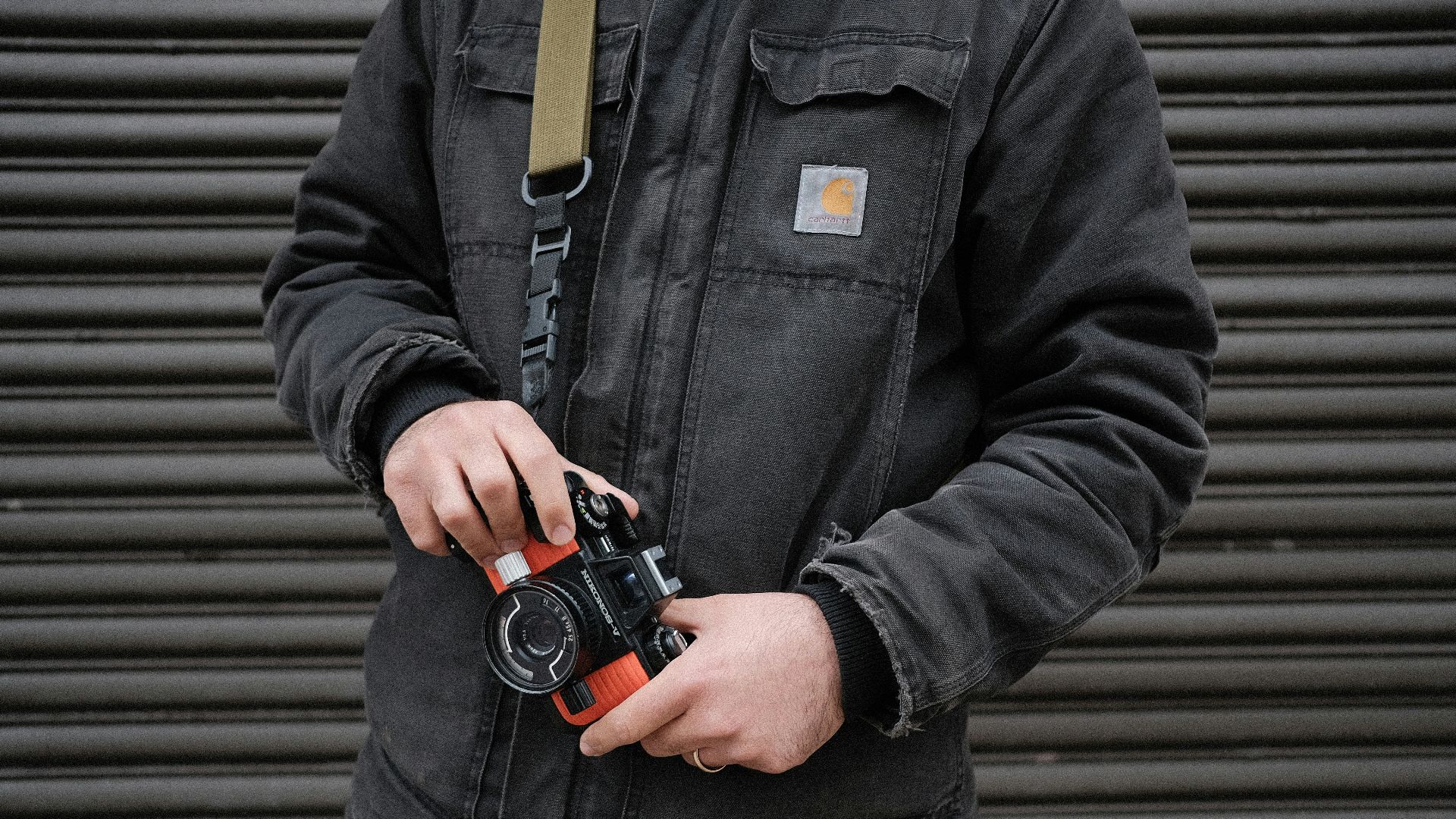 person holding black DSLR camera