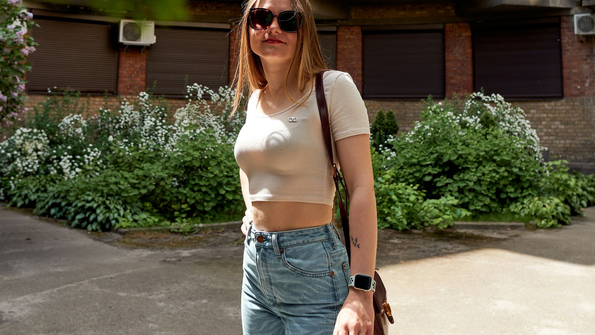 a woman standing on a skateboard in front of a building