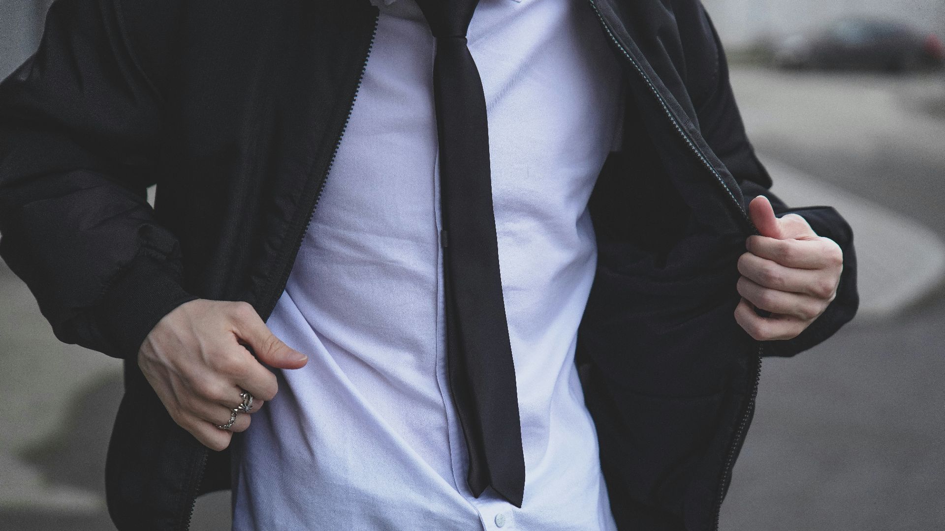 A man is wearing a suit jacket and tie.