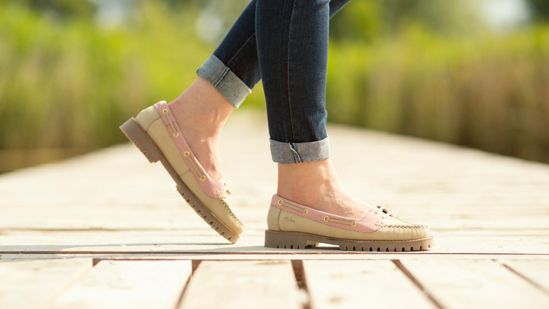 A person walking on a wooden platform in a park