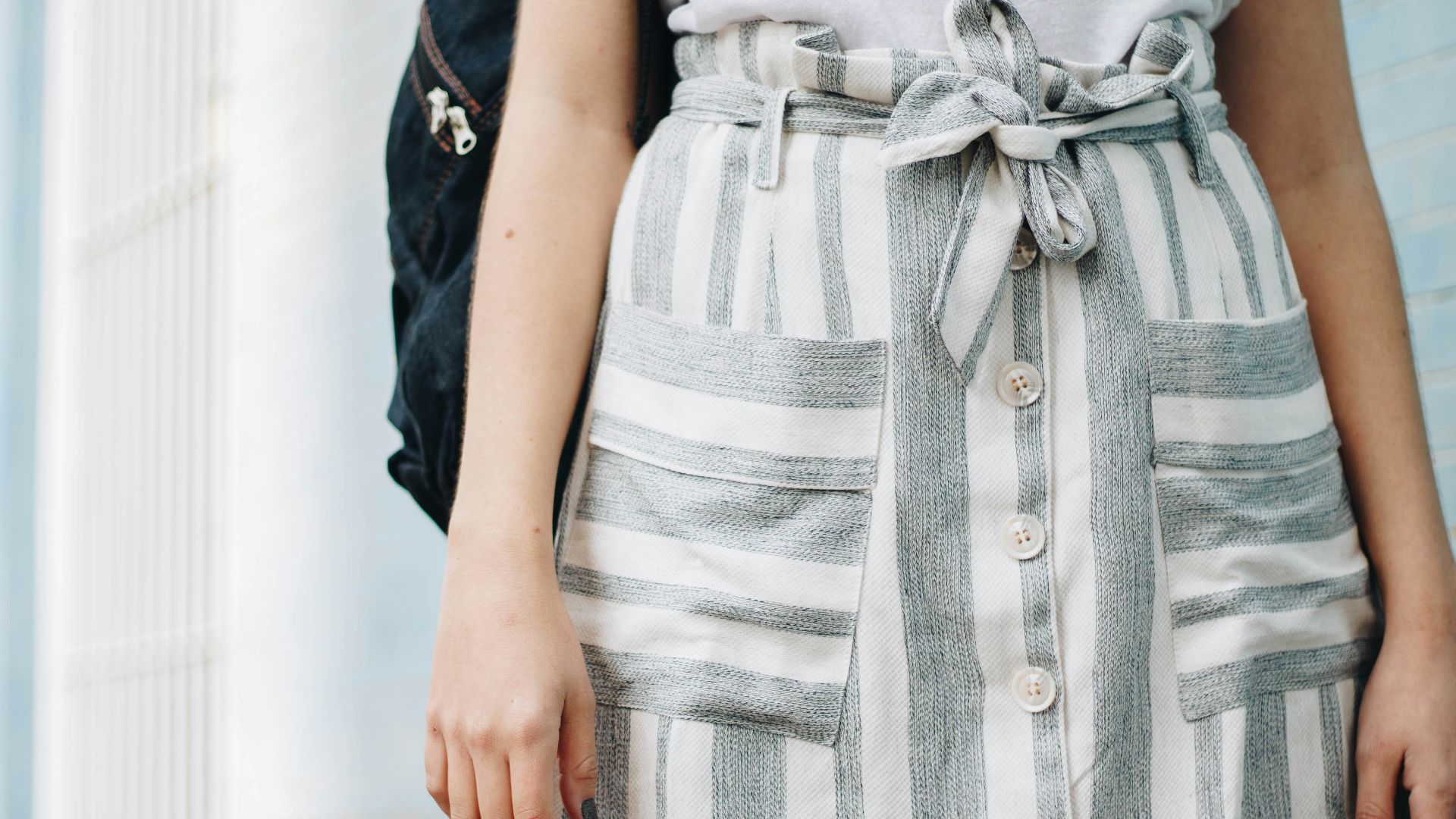 person wearing gray and white striped minidress