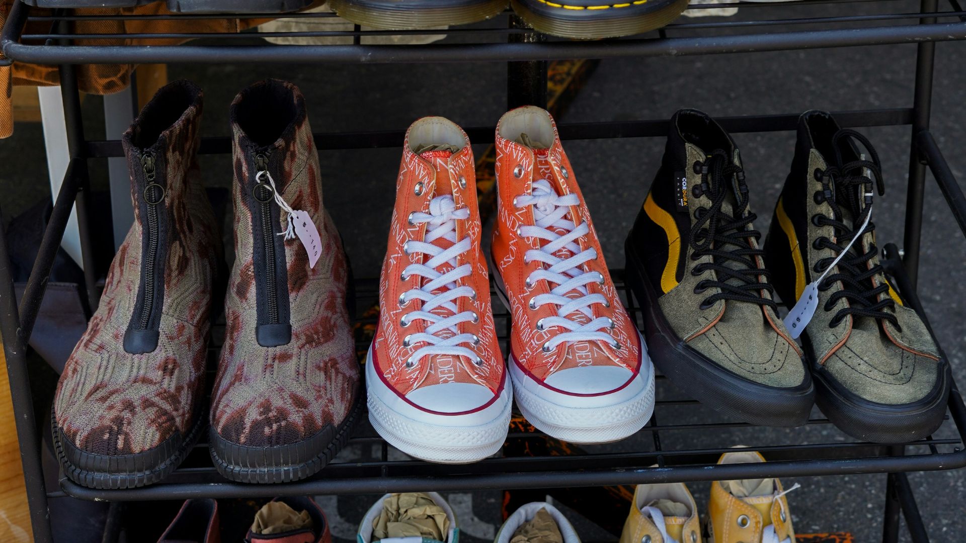 several pairs of shoes are on a rack