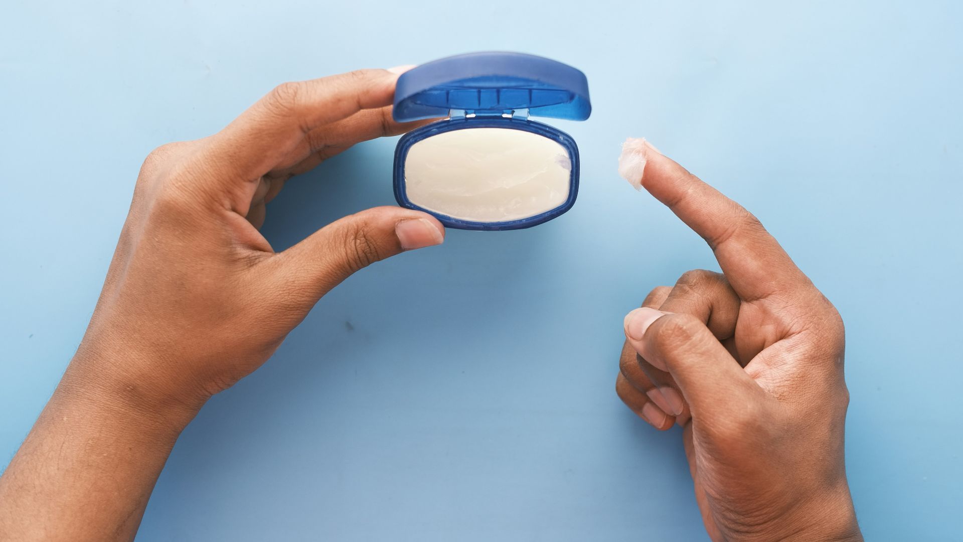 person holding blue round container