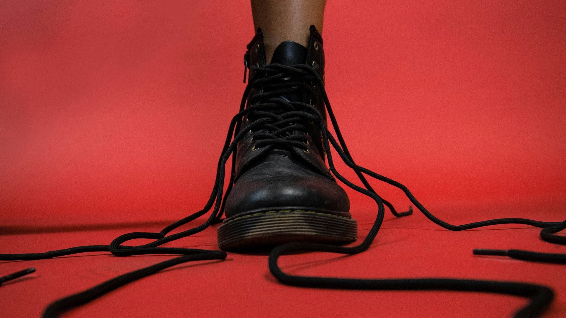 person wearing black leather boots