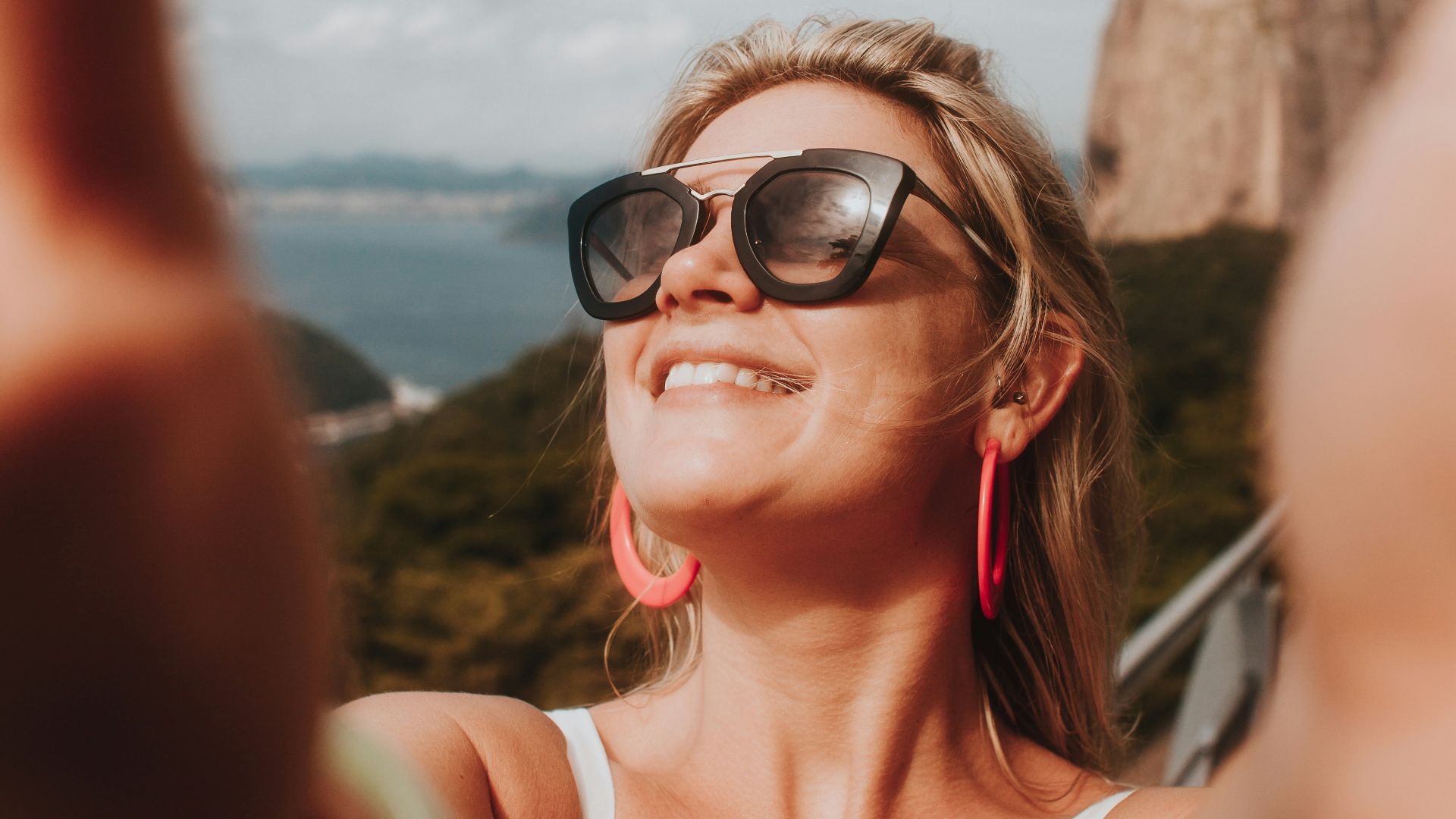 woman in white tank top wearing black sunglasses