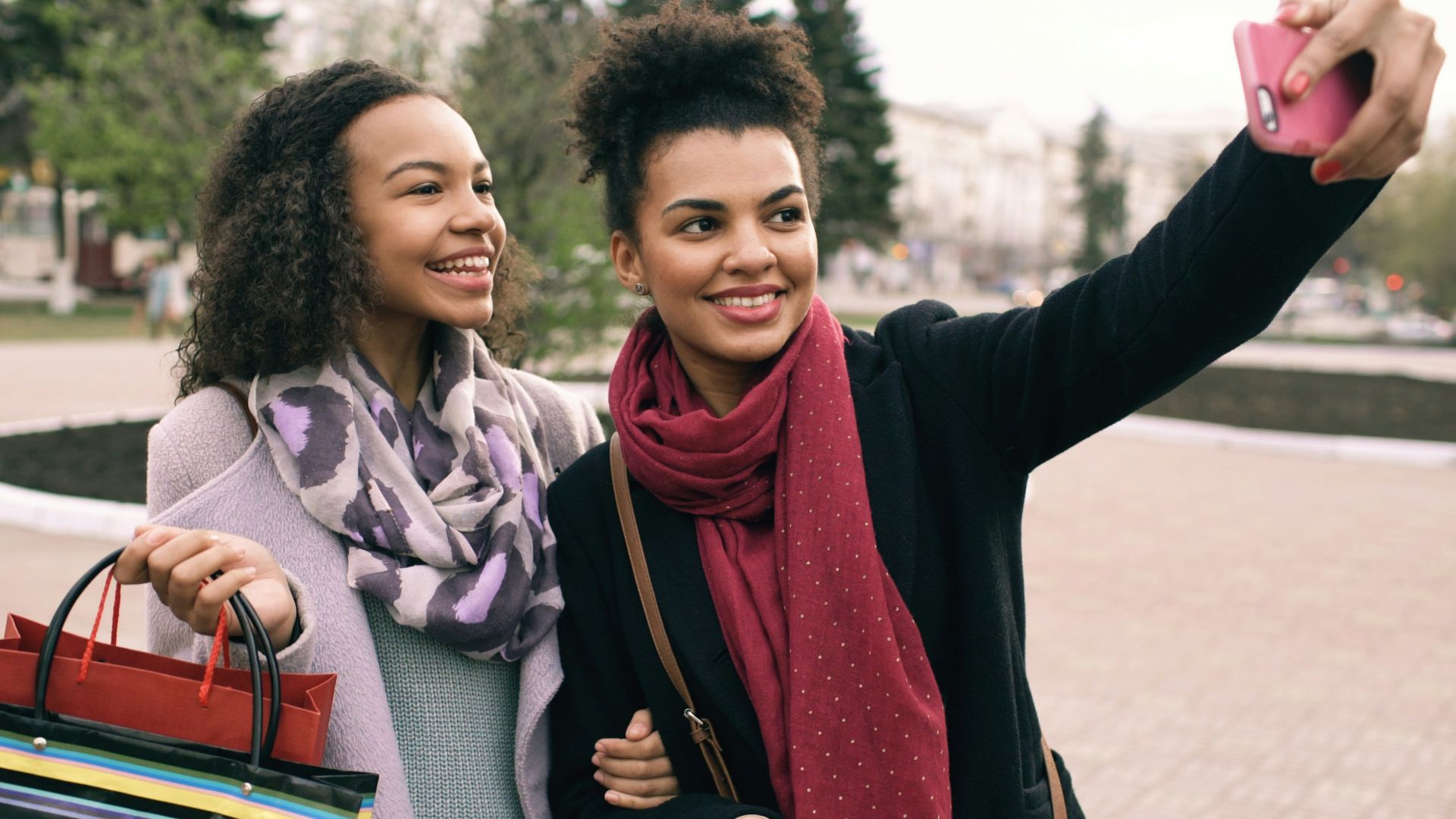 Two friends taking a selfie after shopping