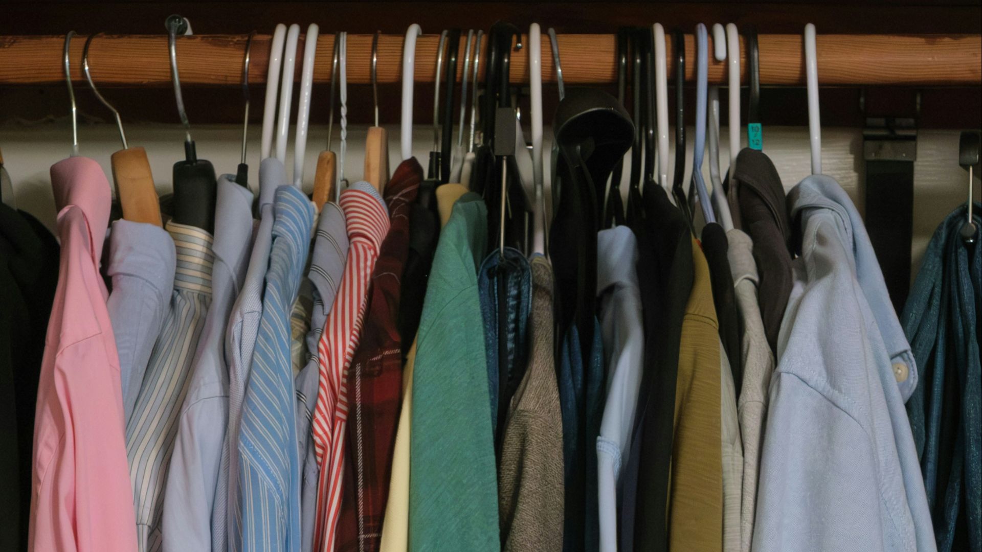 A closet full of neatly hung clothes.