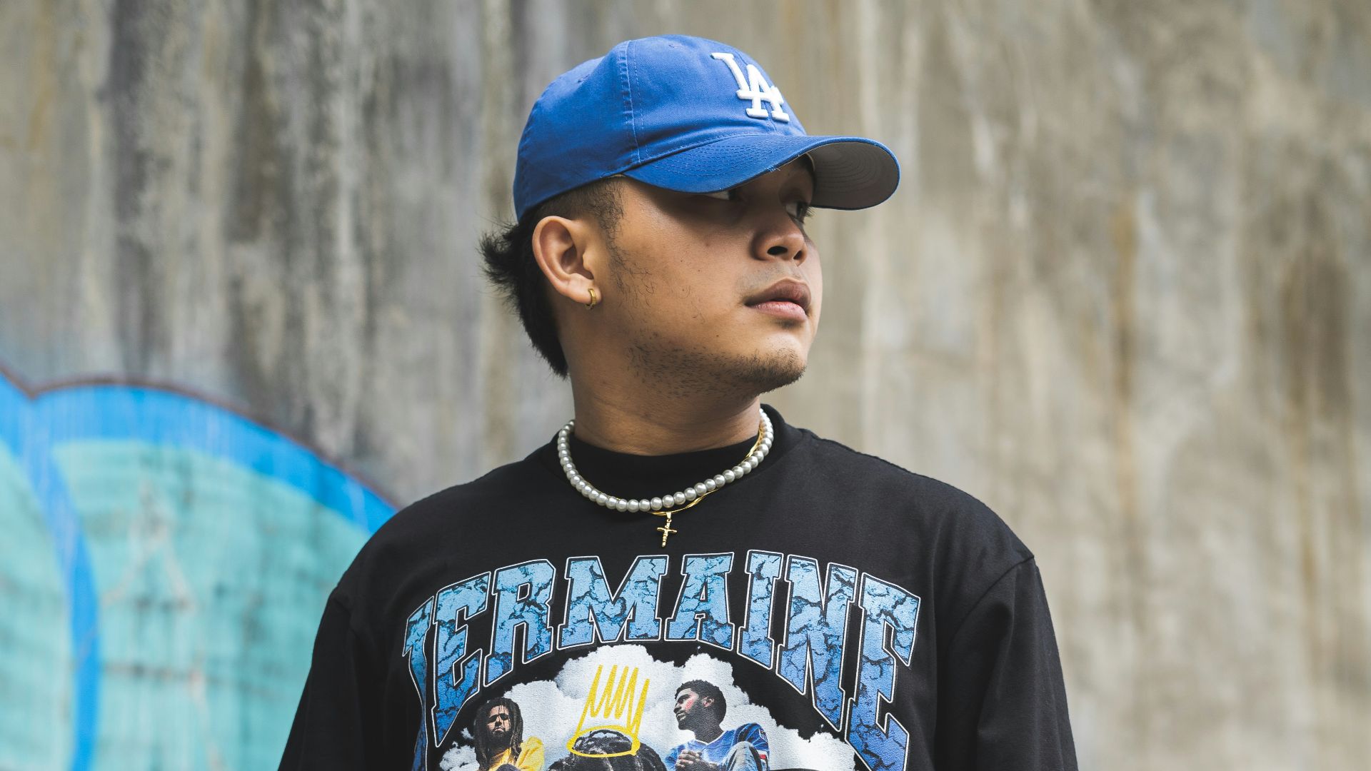 boy in black and white crew neck t-shirt standing near wall