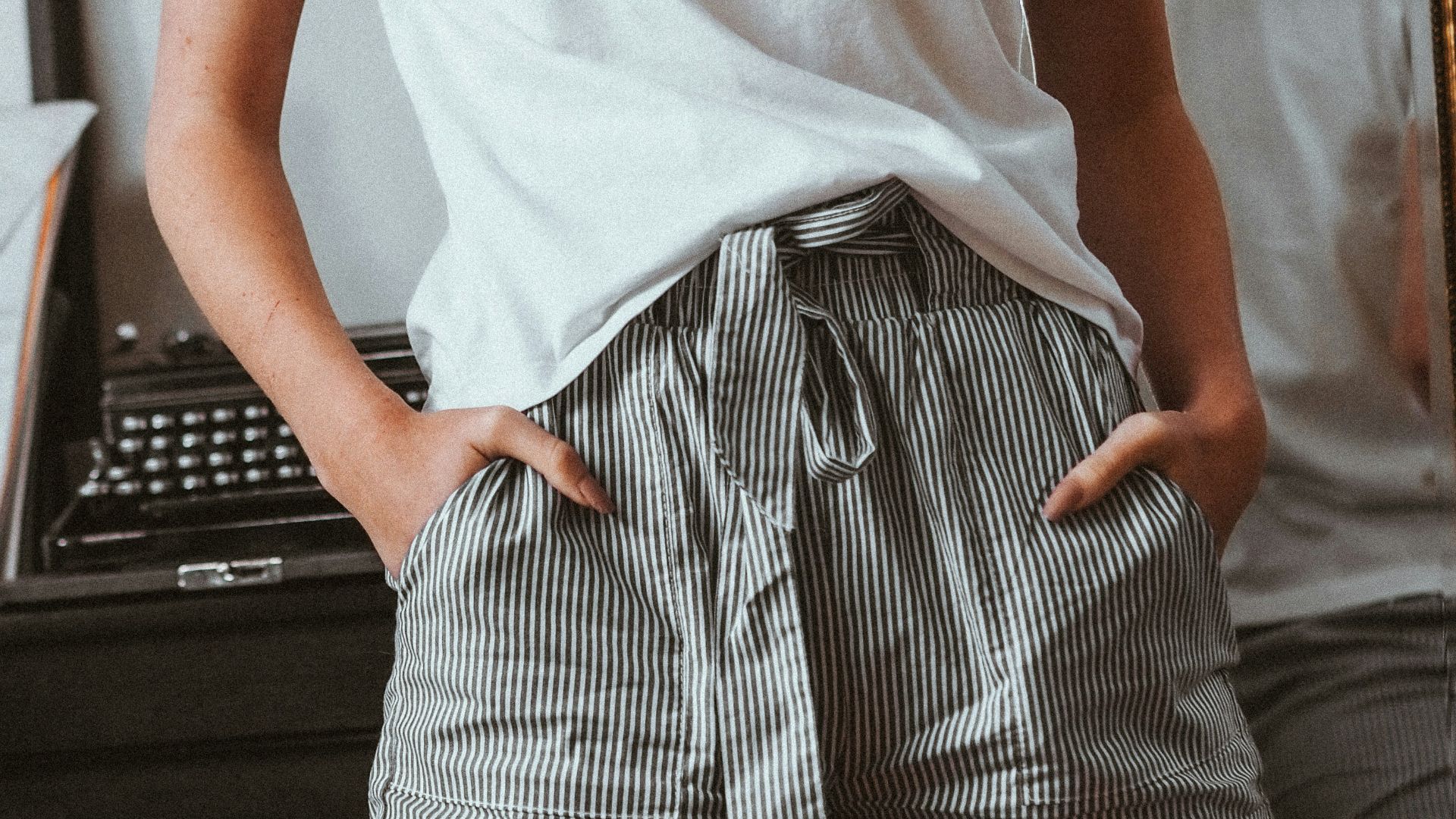 woman in white crew neck t-shirt and black and white striped skirt