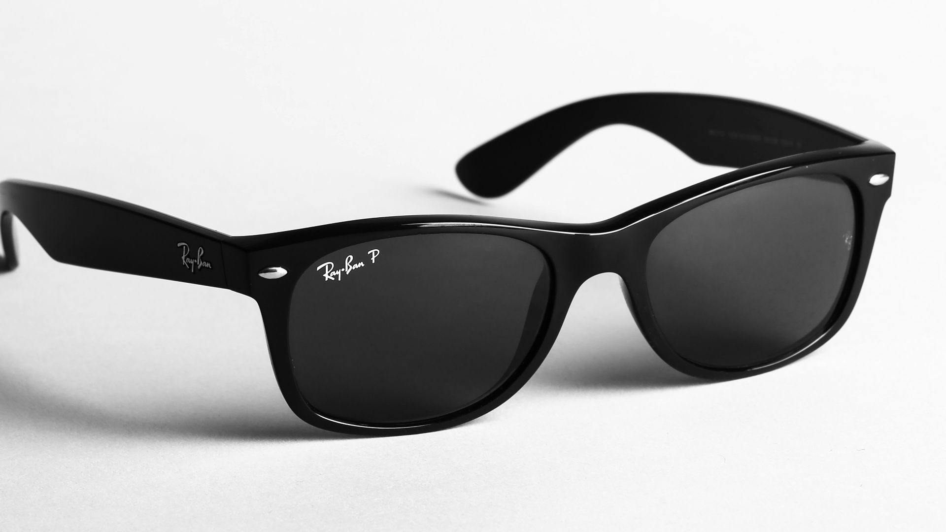 shallow focus photo of black Ray-Ban wayfarer sunglasses