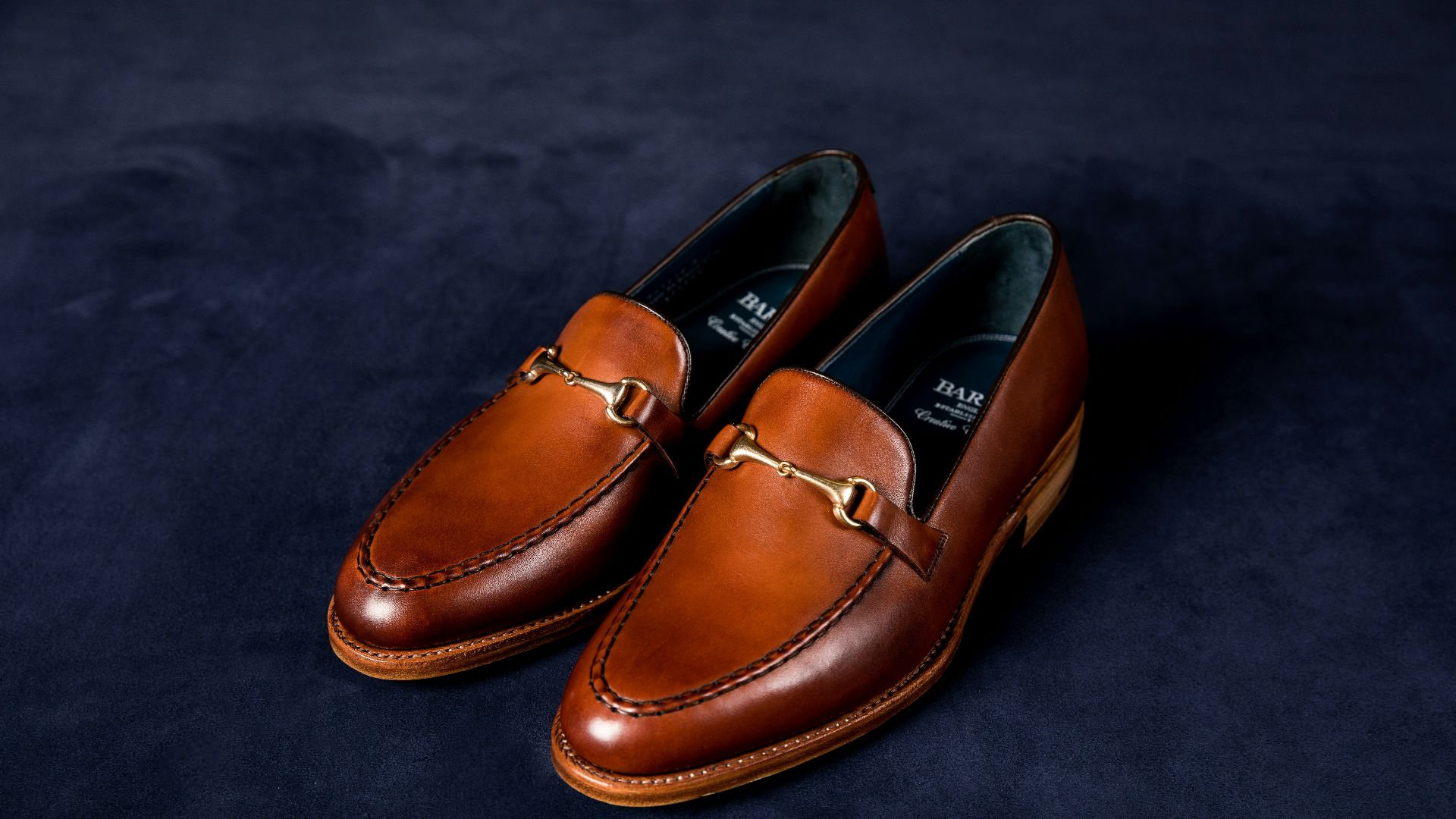 brown leather loafers on blue textile