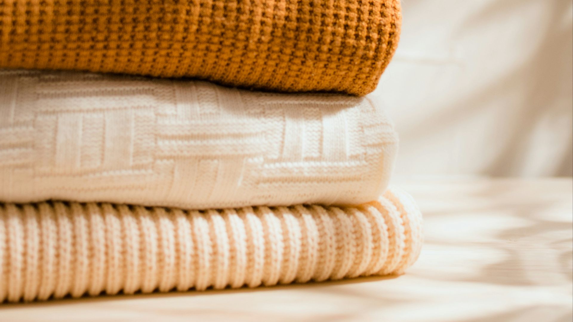 a stack of folded towels sitting on top of a table