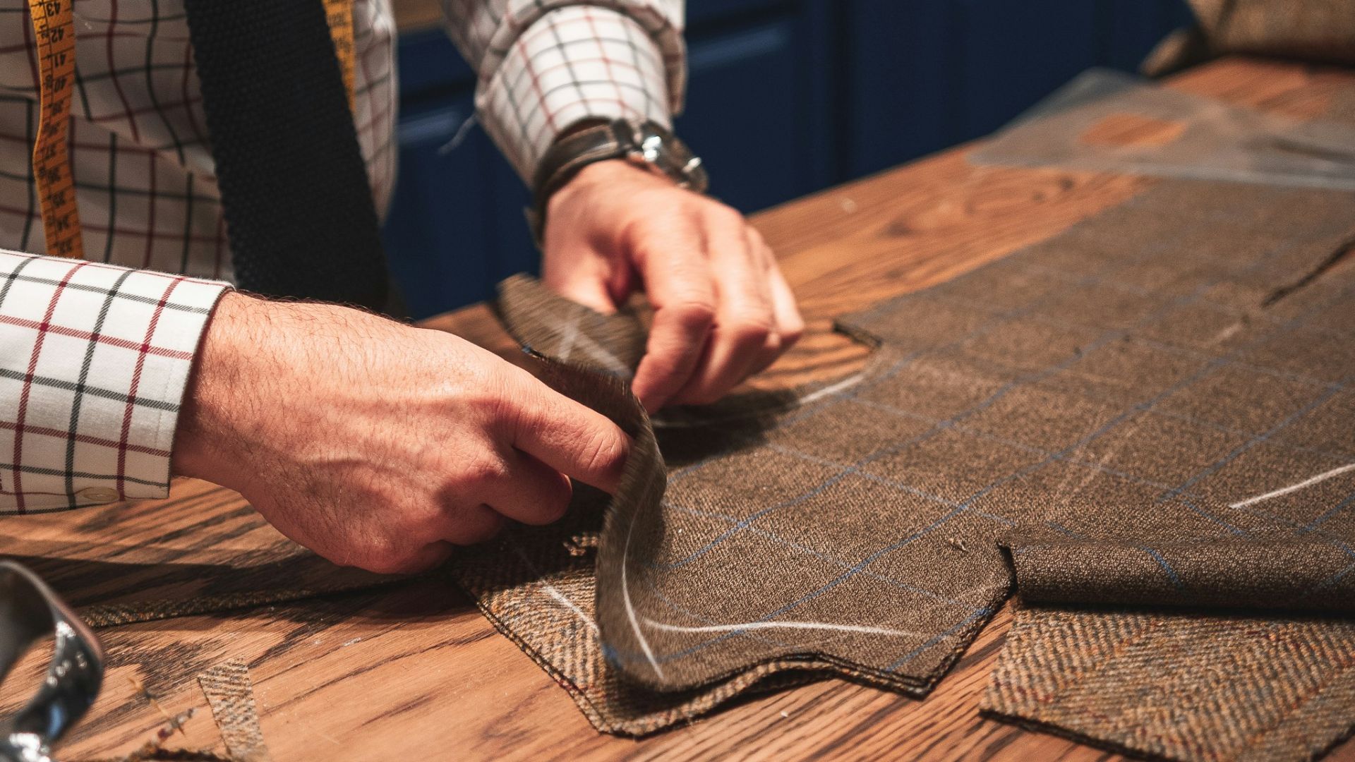 person in black suit holding brown leather bag