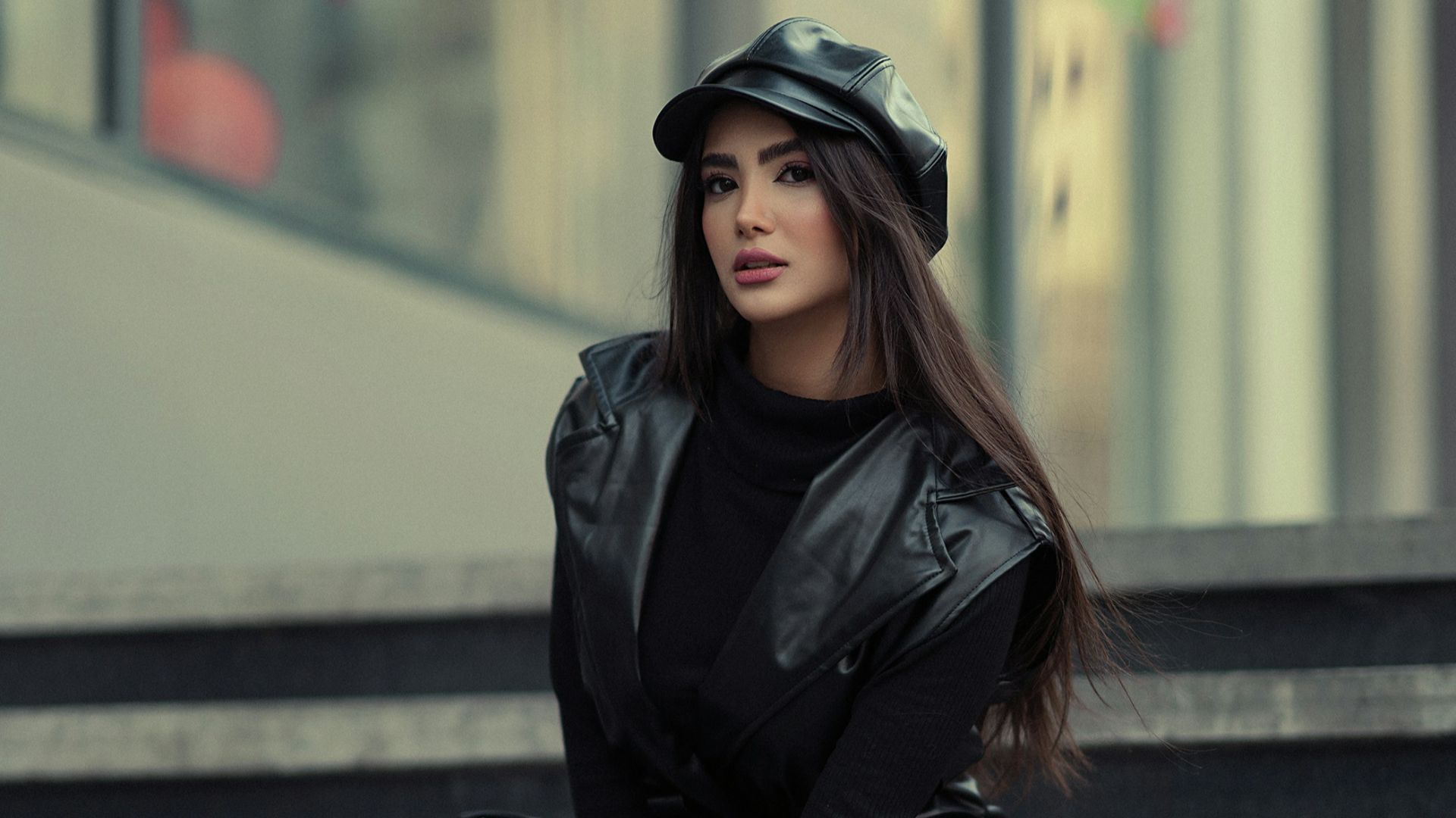 a woman sitting on the steps of a building