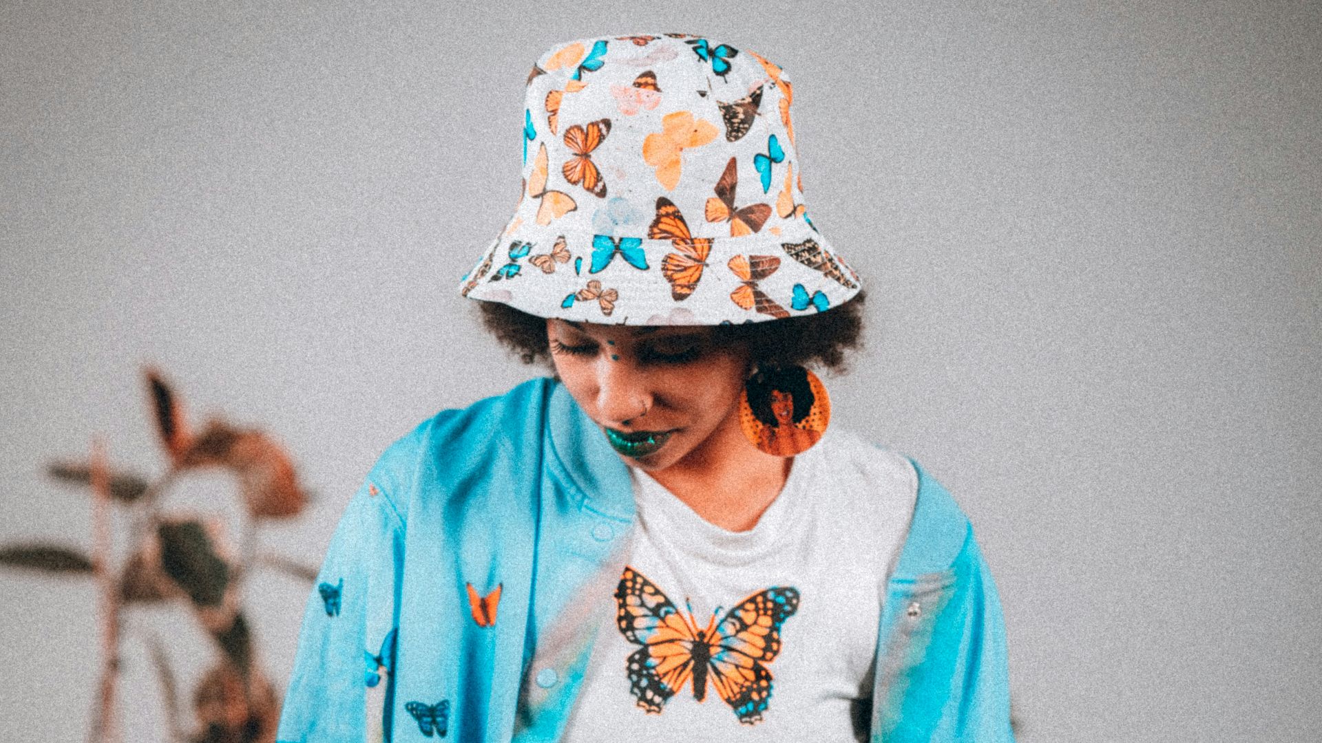 woman in blue and white floral long sleeve shirt and black skirt