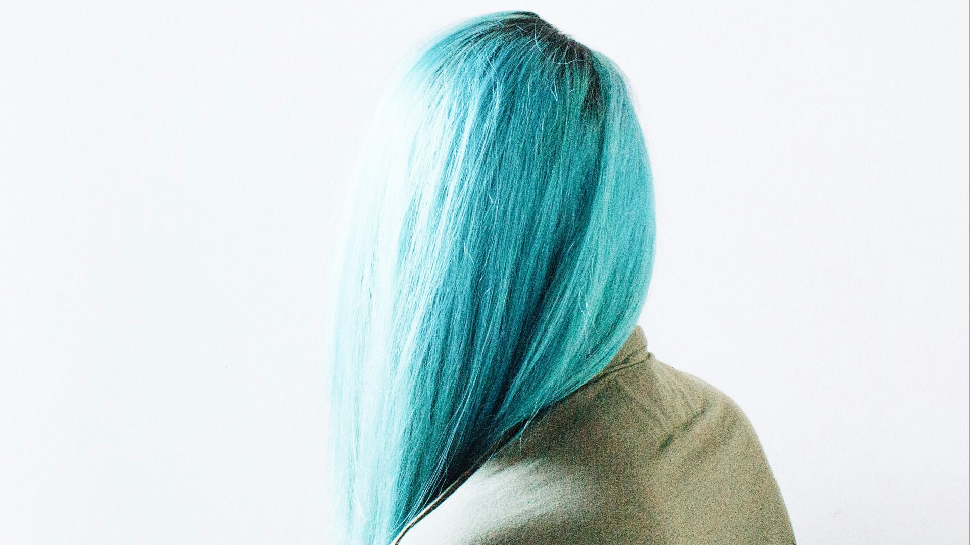 teal-haired woman wearing brown top