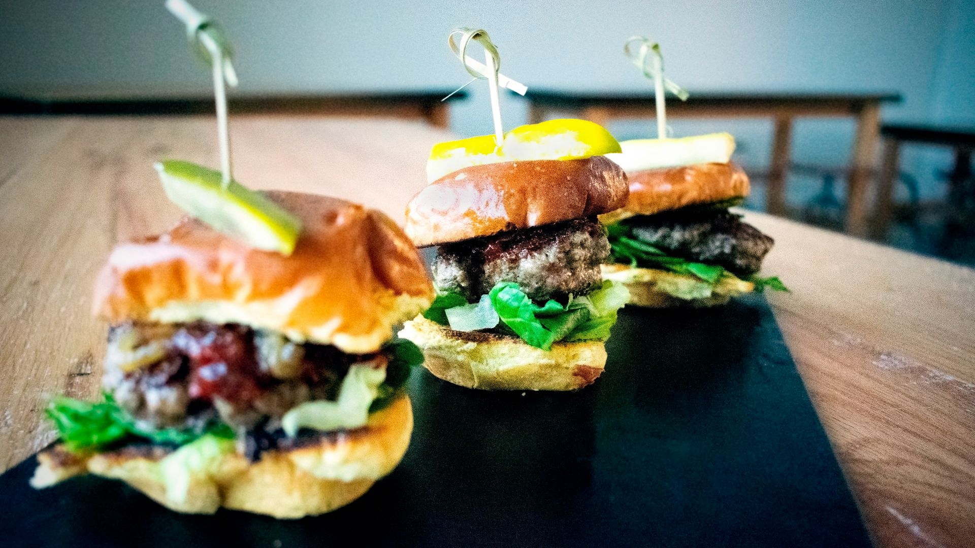 a couple of sandwiches sitting on top of a wooden table