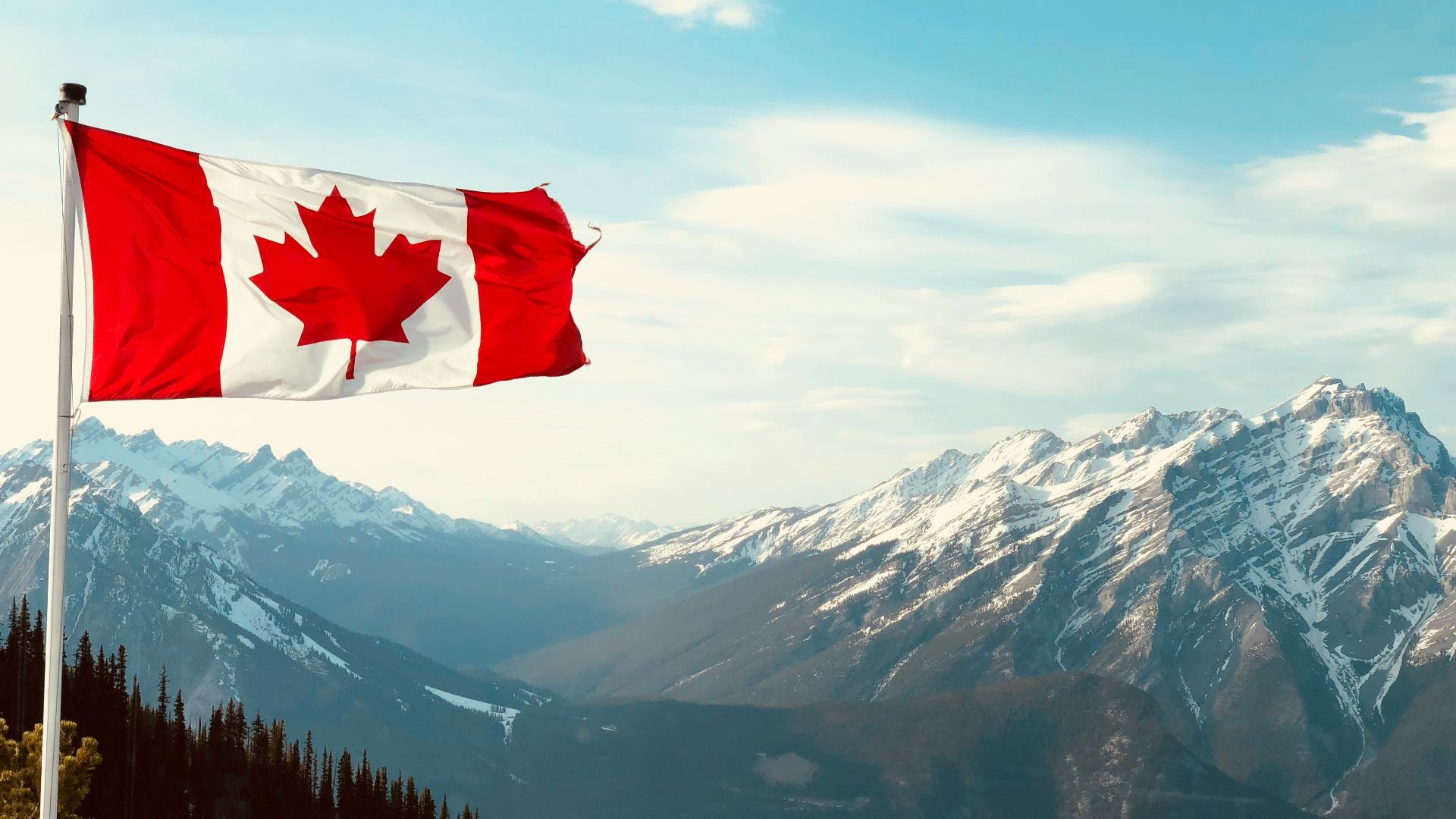 red and white flag on top of the mountain