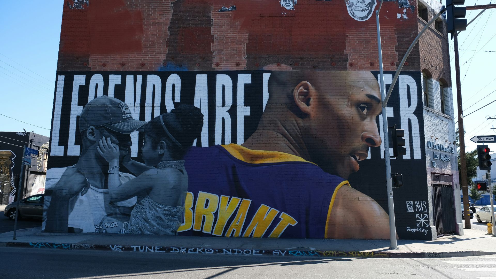 man in yellow and blue tank top sitting on black metal bench