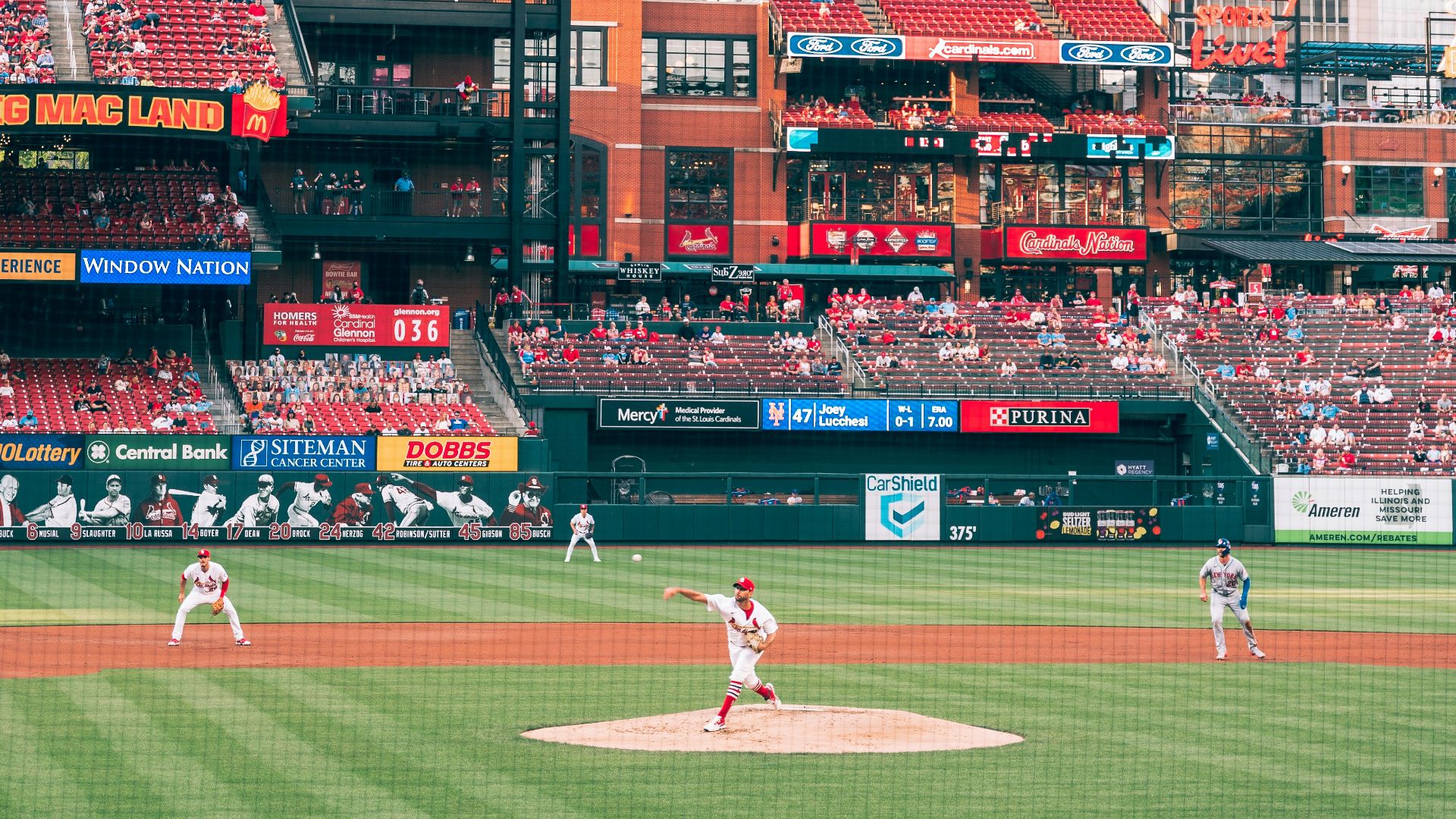 red and white stadium in city during daytime