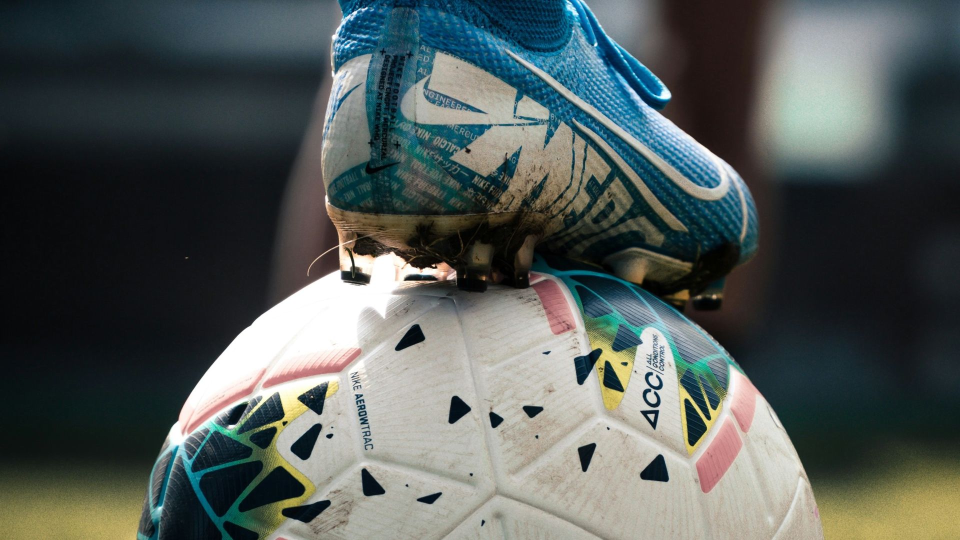 white and blue soccer ball on green grass field
