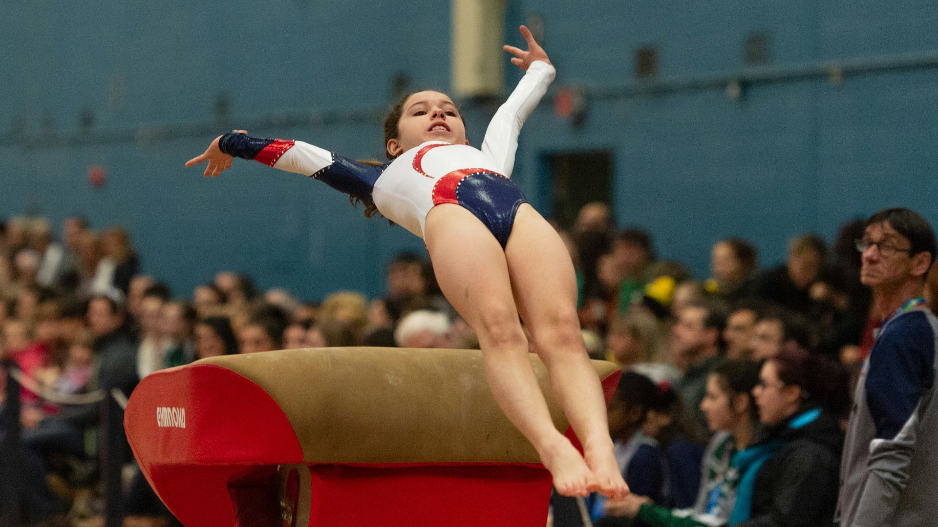 woman in black sports bra and black leggings lying on brown concrete bench