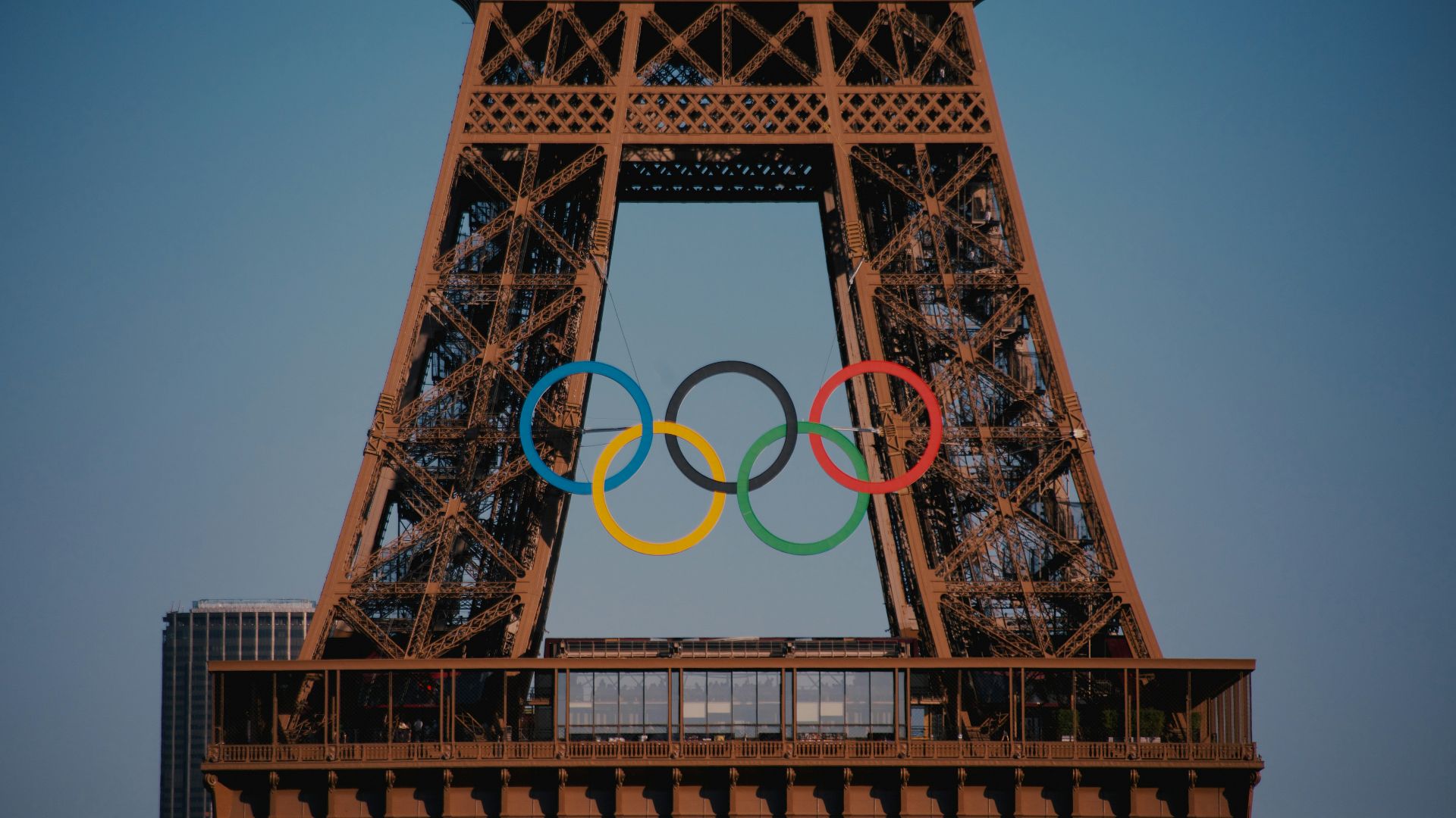 The eiffel tower with the olympic rings in front of it