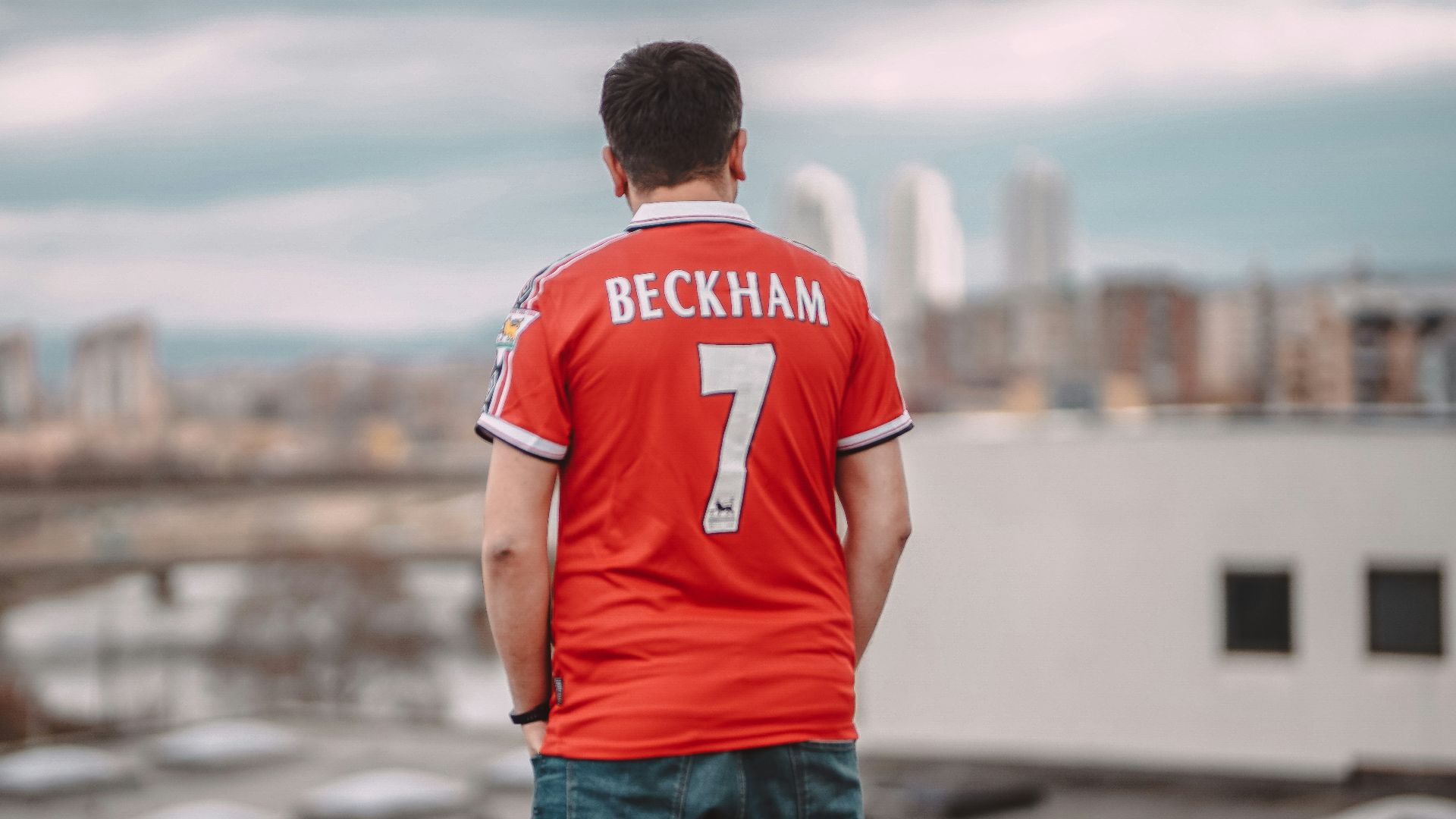 a man standing on top of a roof next to a building
