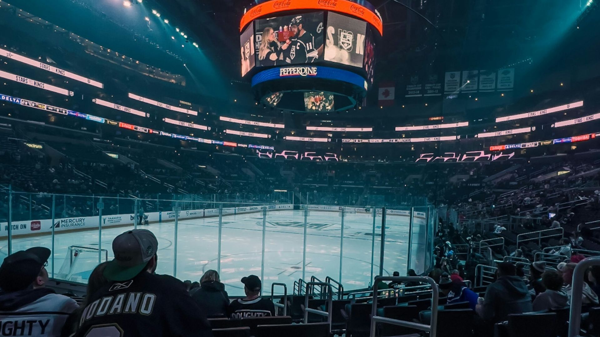 a hockey stadium filled with fans watching a game