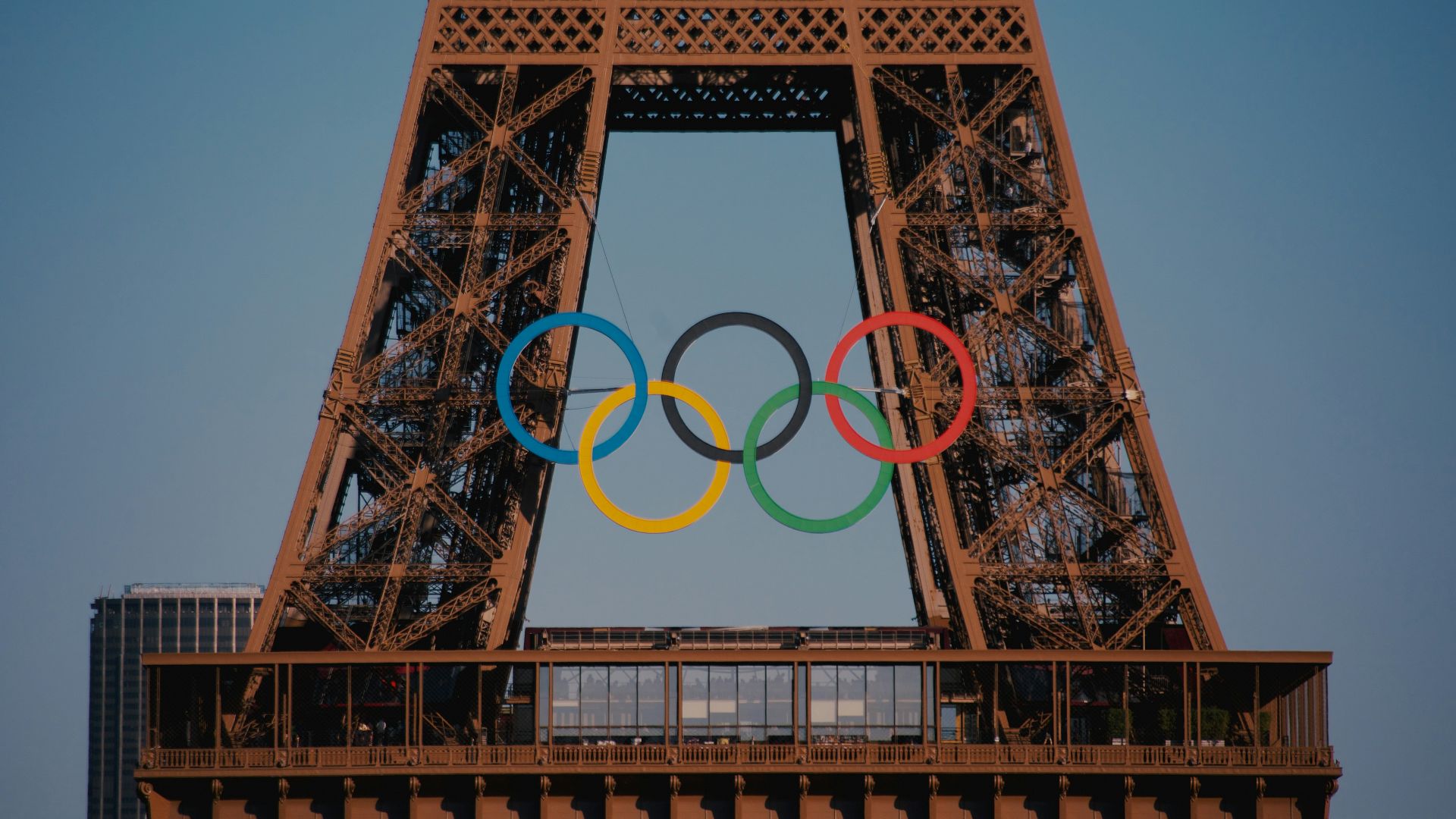 The eiffel tower with the olympic rings in front of it