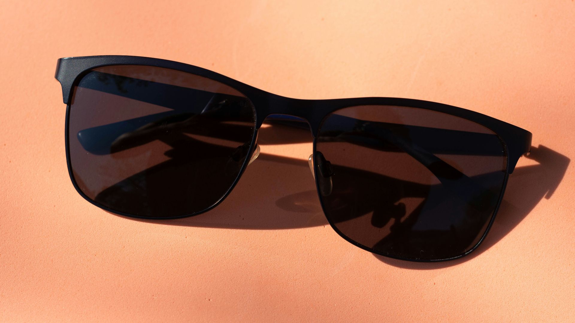 black framed sunglasses on white table