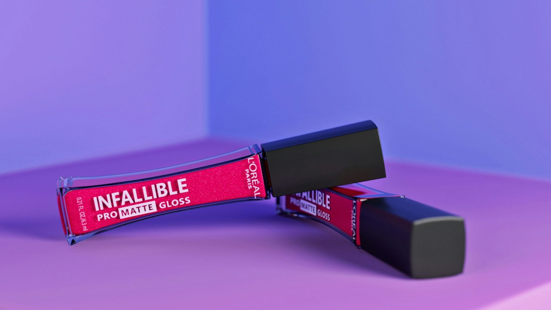 a pink and purple background with a lipstick tube