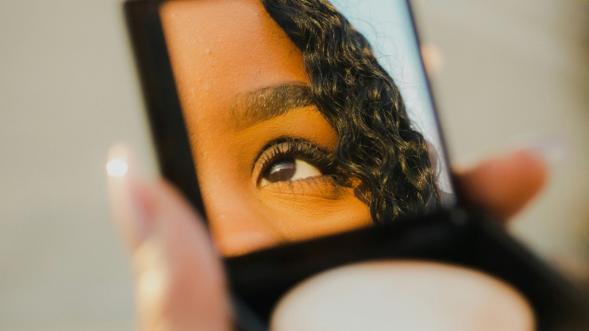 a woman holding a compact compact compact compact compact compact compact compact compact compact compact compact
