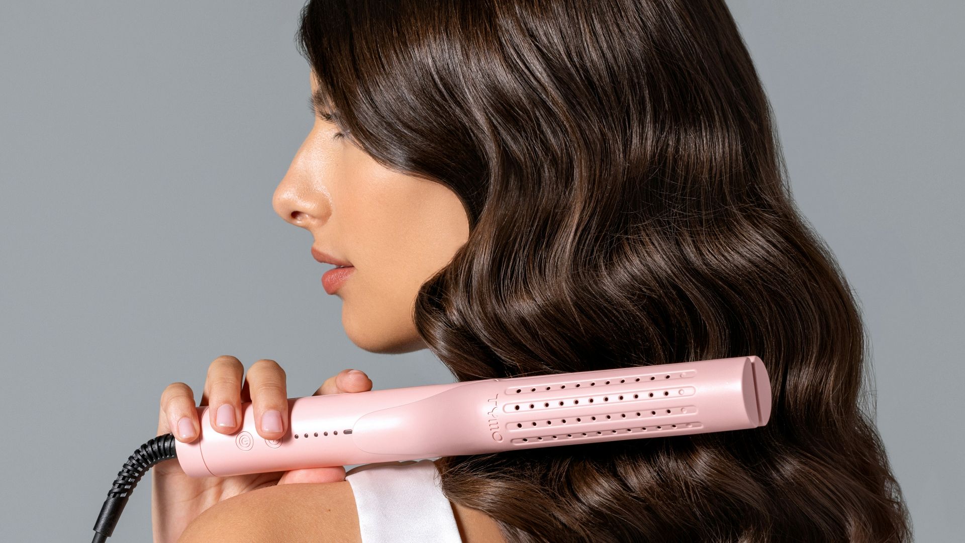 a woman using a hair dryer on her back