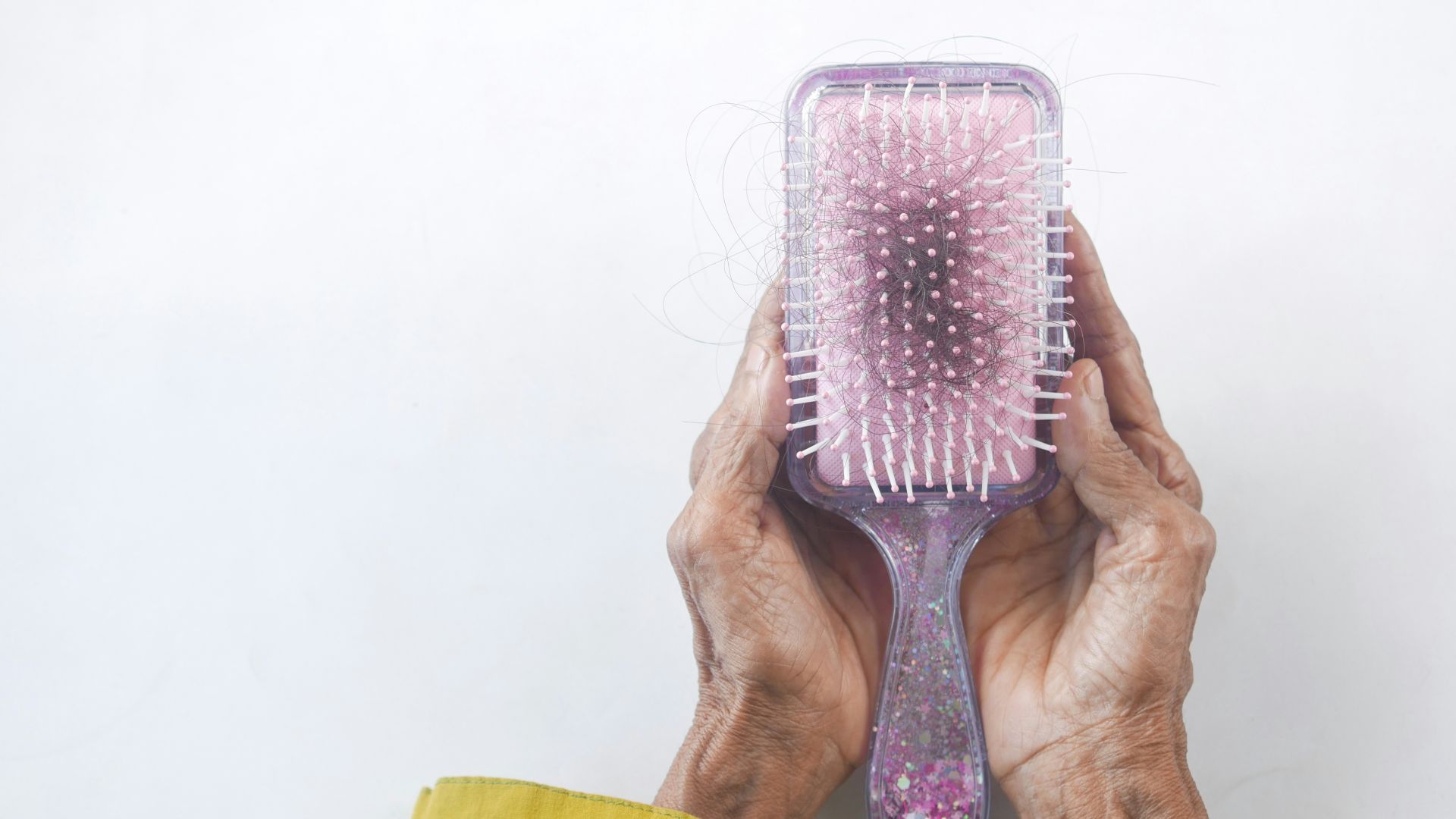 a person holding a hair brush in their hands