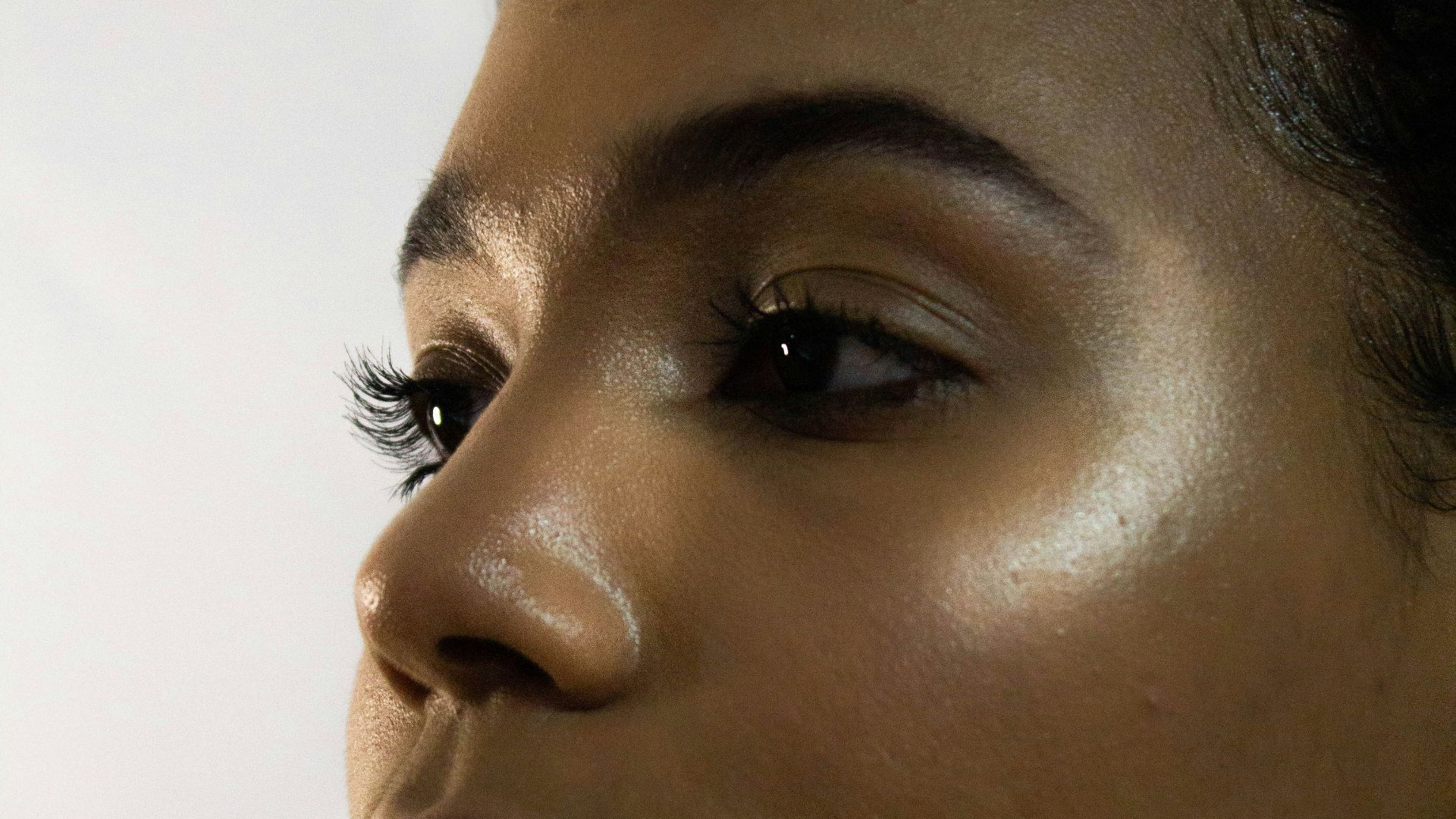 woman with black hair and wearing silver earrings