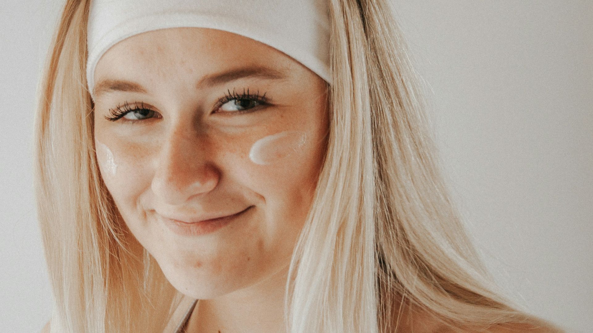 woman in white tank top smiling