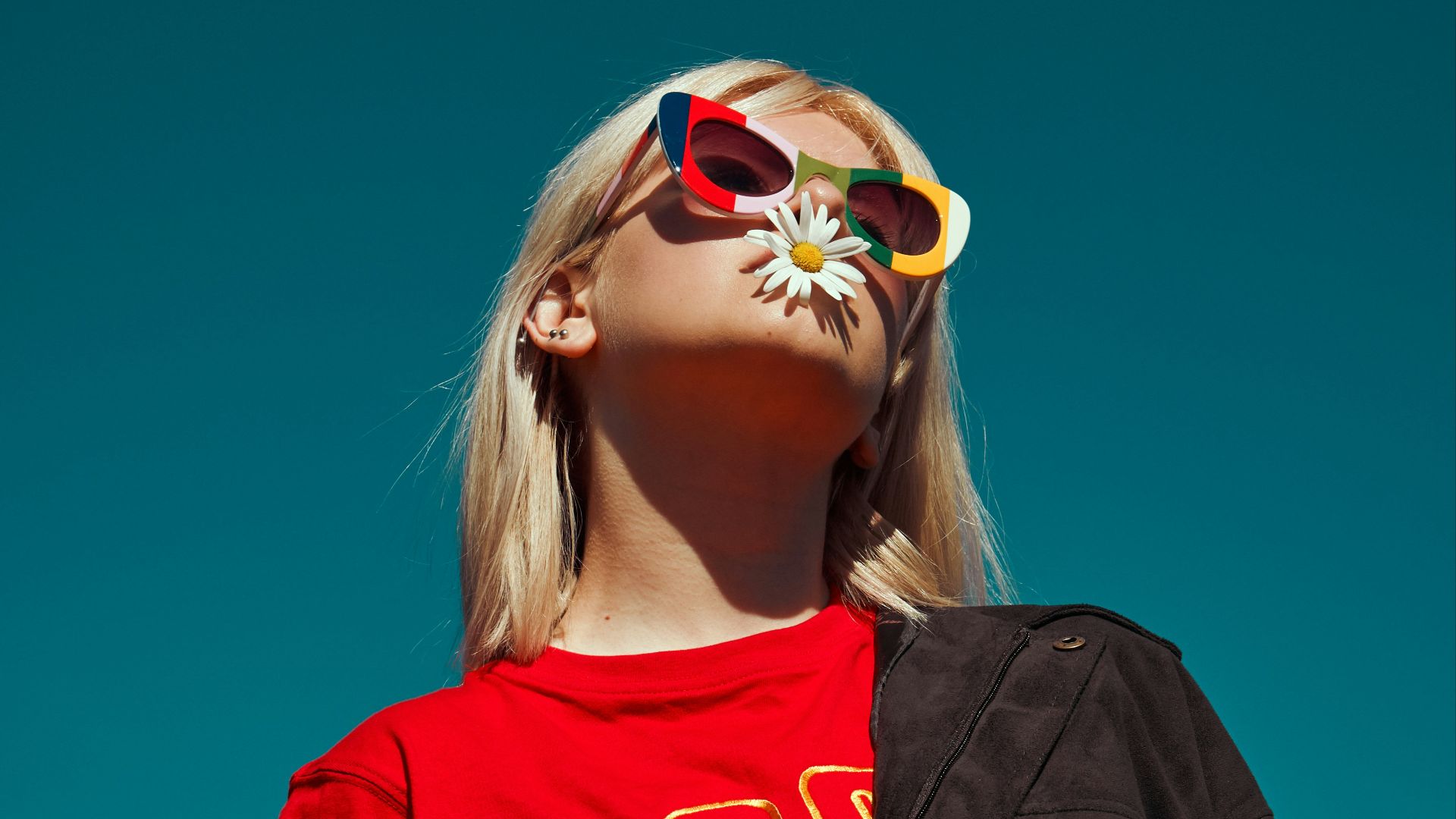 woman with sunglasses standing outdoor during daytime