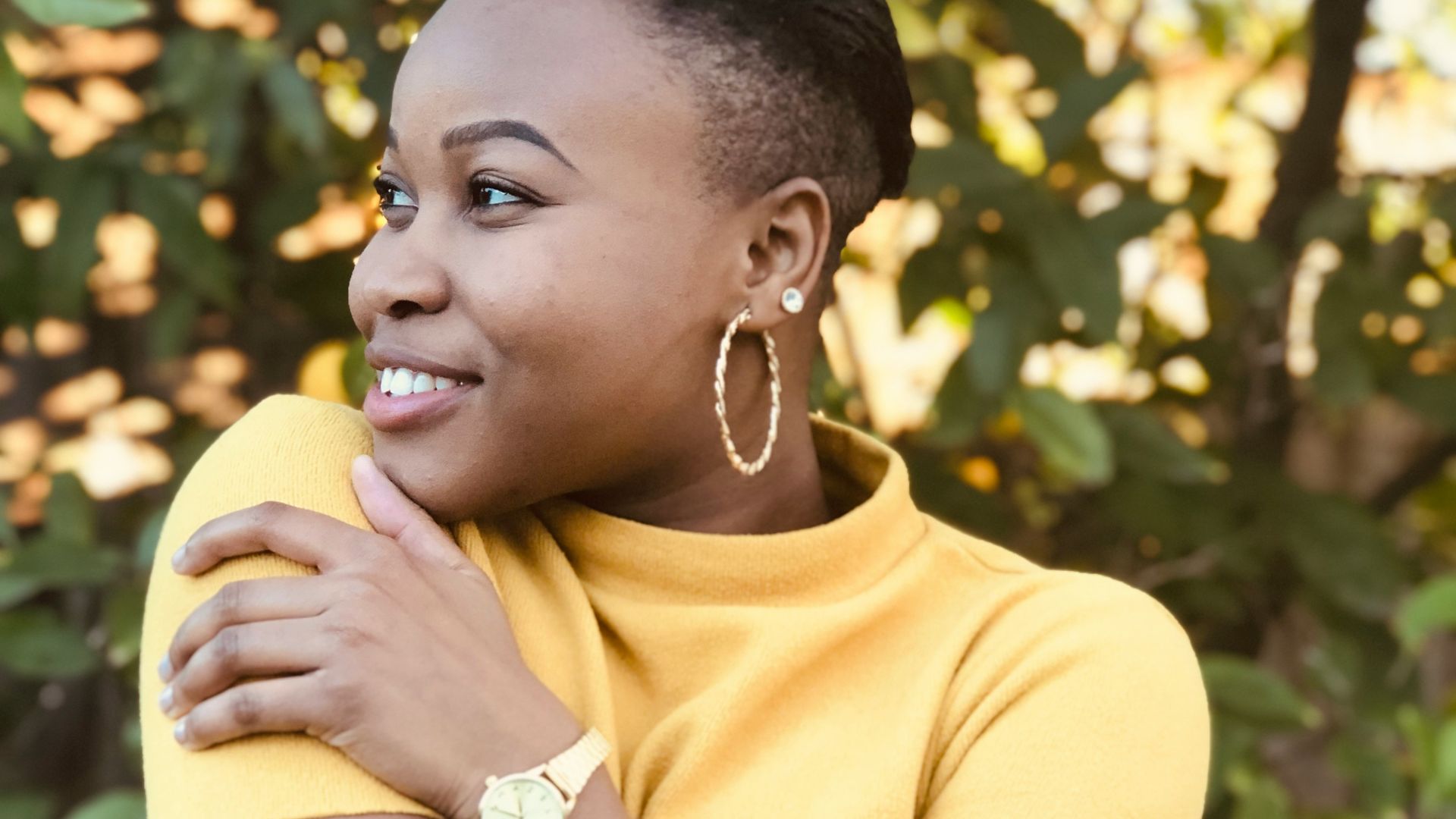 woman in yellow shirt holding yellow fruit