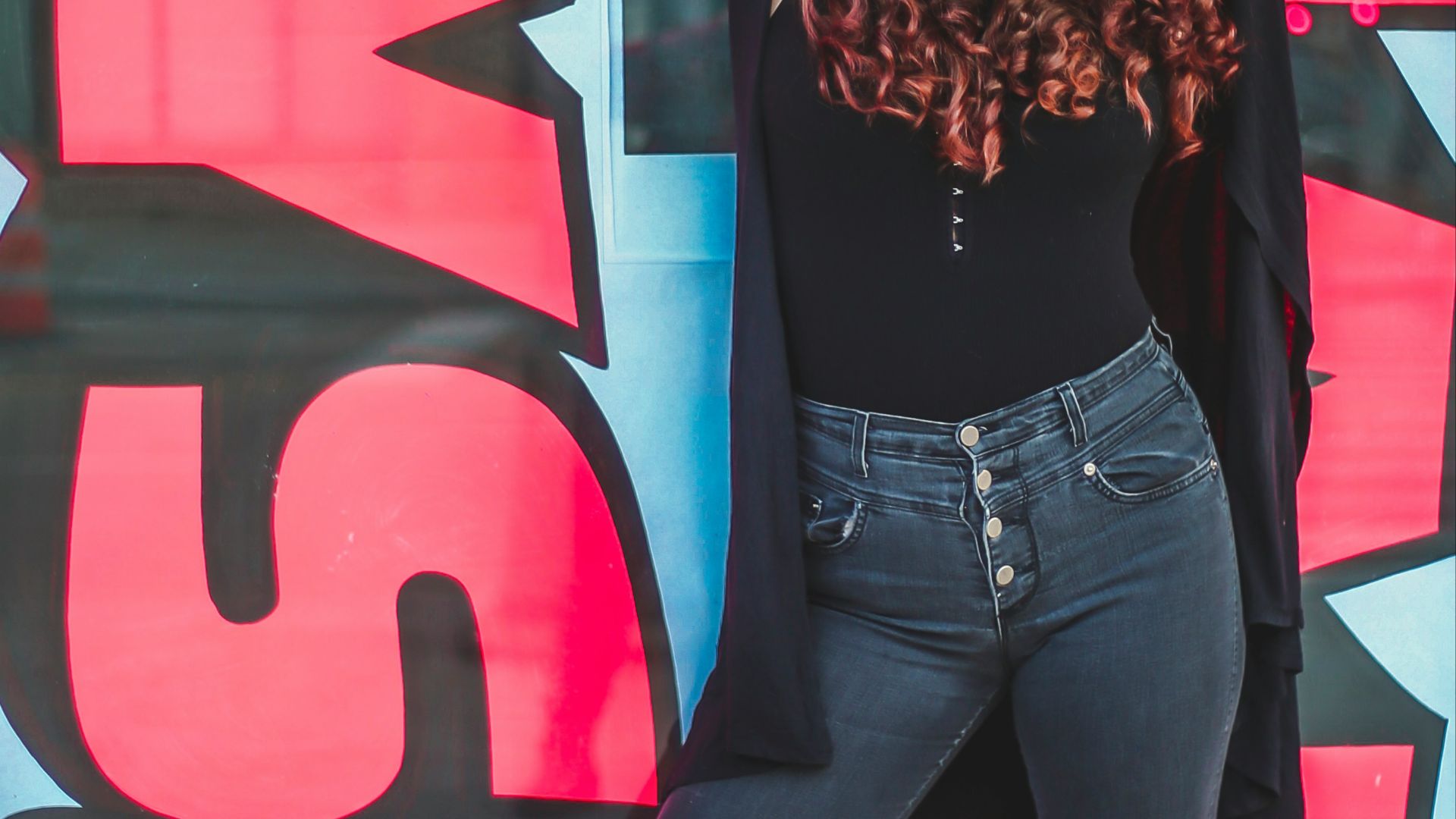 woman leaning on wall
