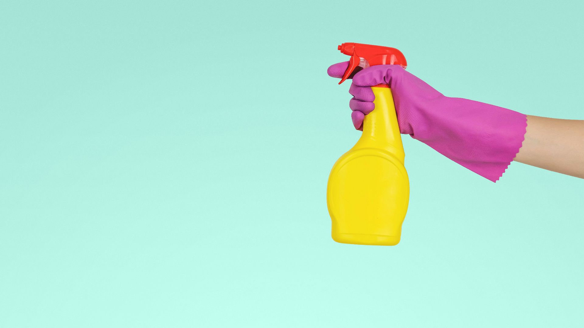 person holding yellow plastic spray bottle