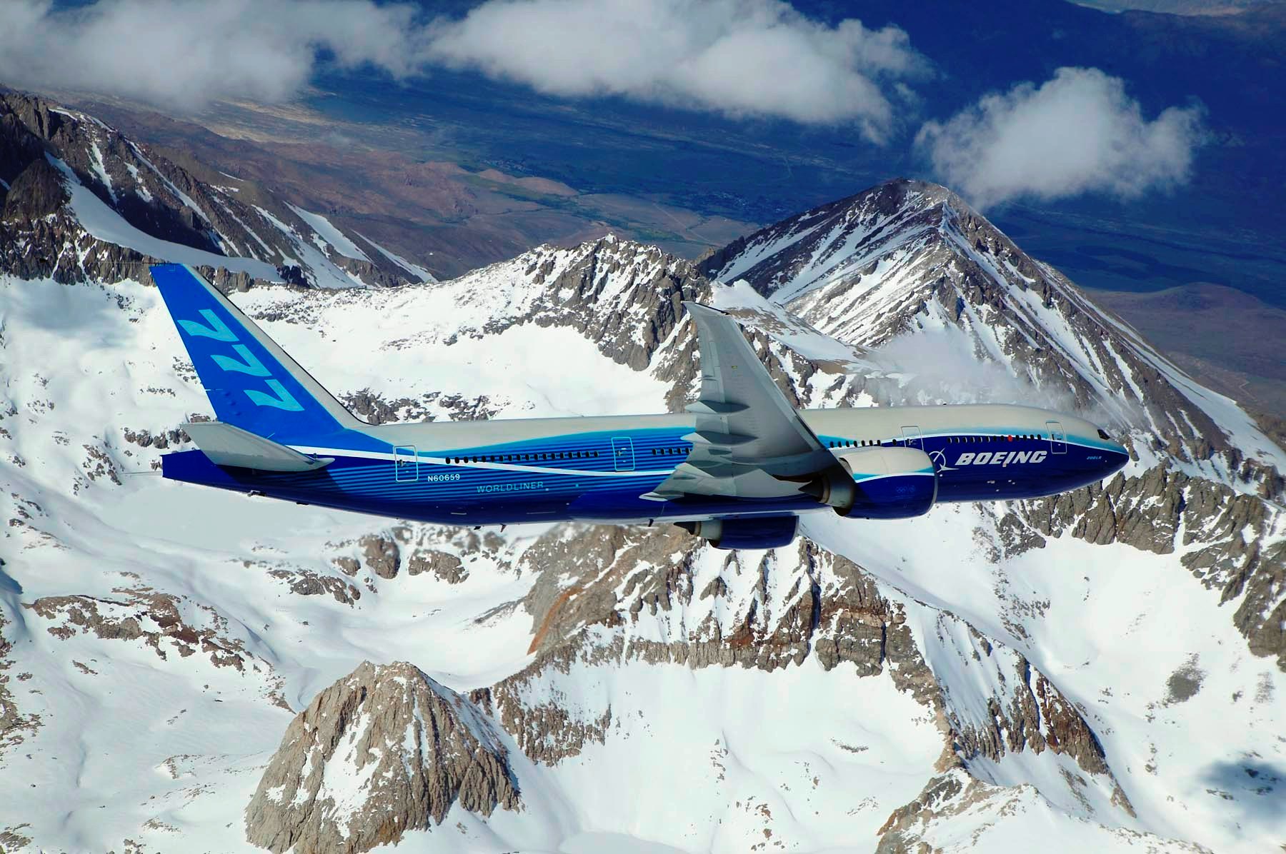 boeing_777-200lr_banking_over_mountain-1551232477460.jpg