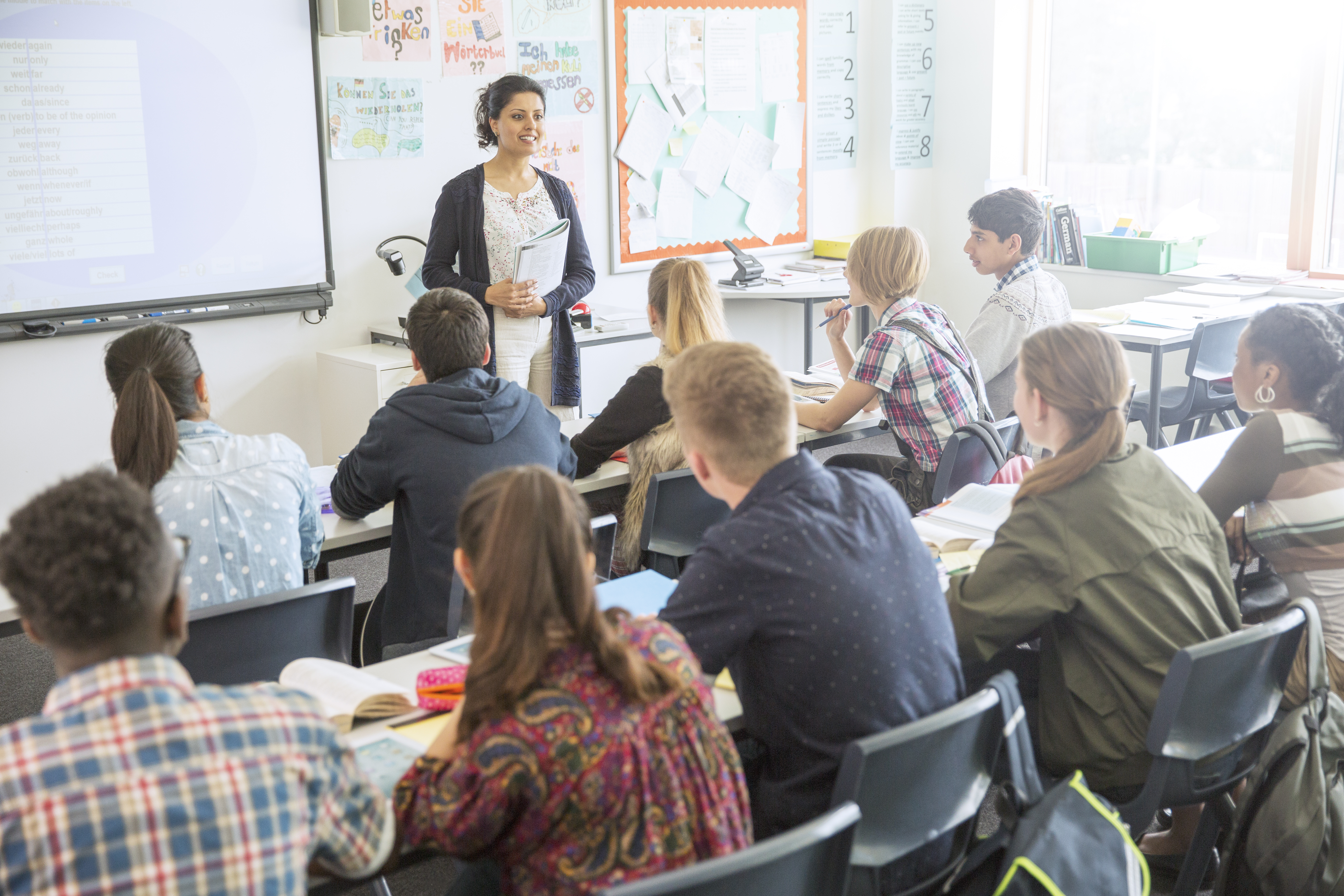 Teacher and students in classroom during lesson.