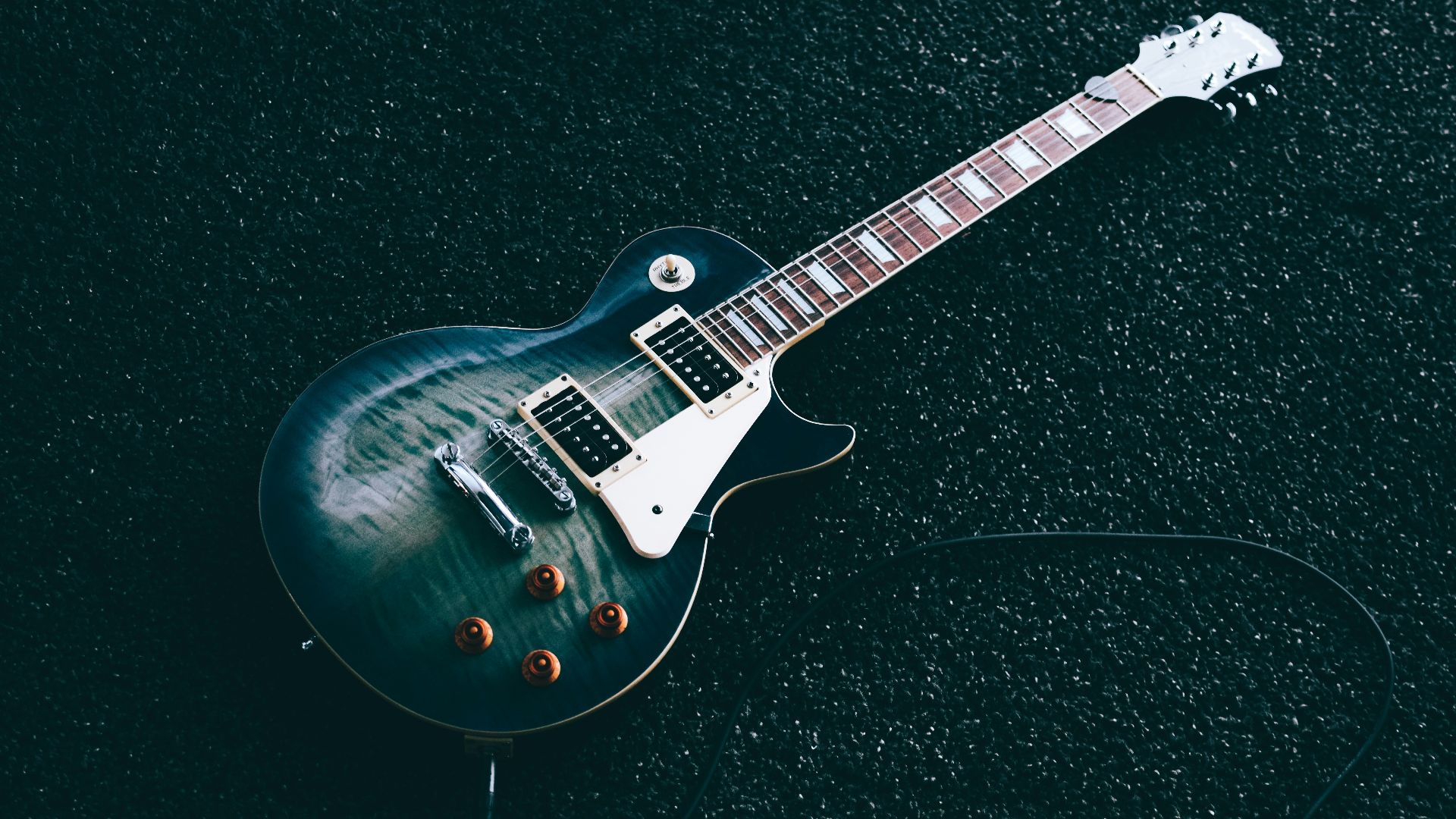 black whiskered single-cutaway electric guitar