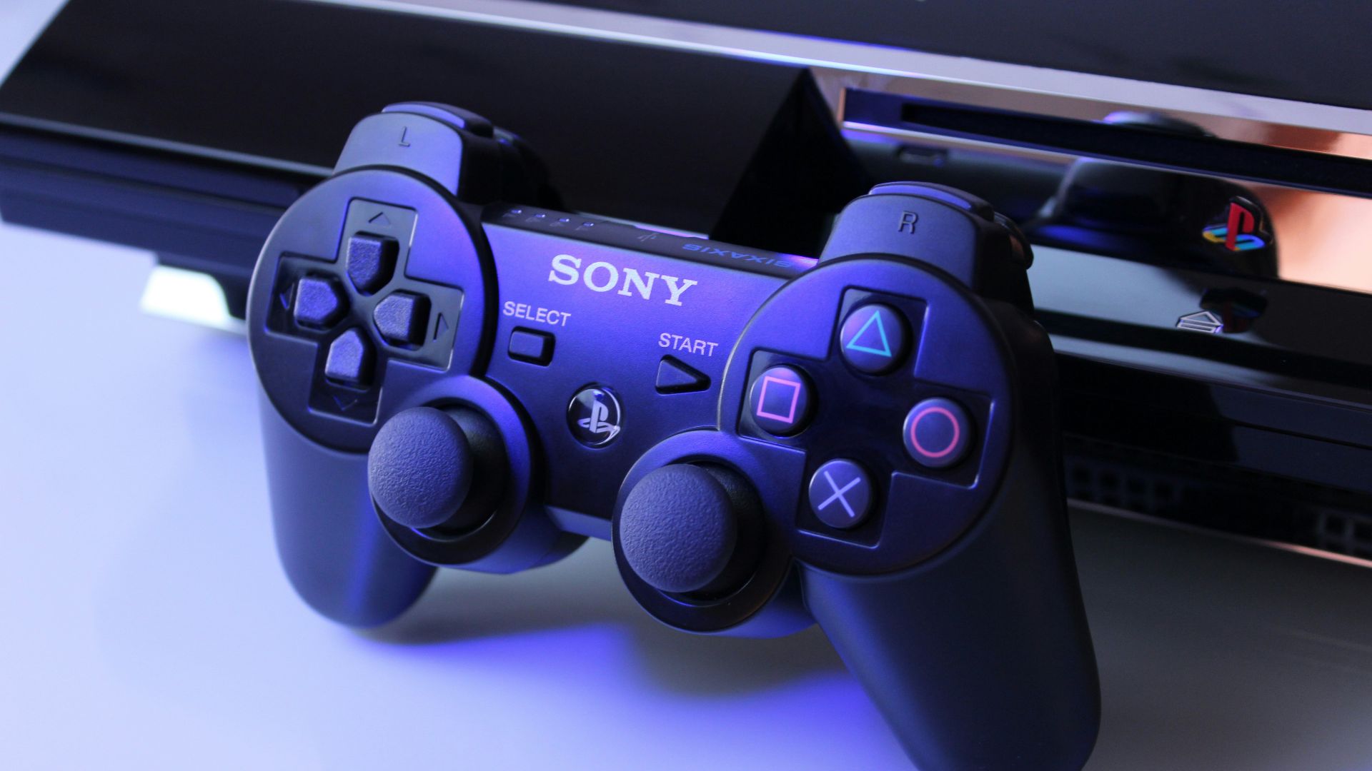 black Sony PS2 controller on white surface