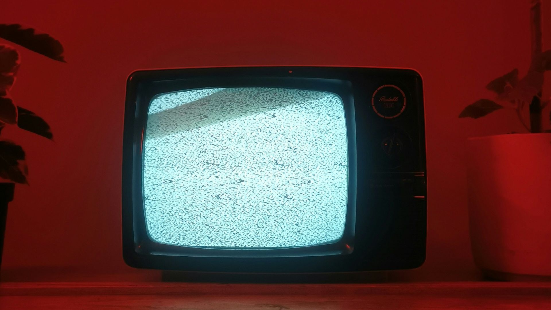 a small television sitting on top of a wooden dresser