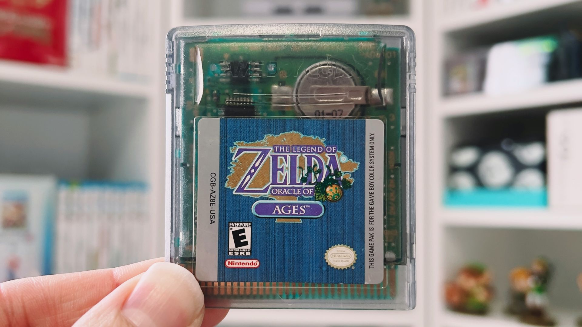 a hand holding a small plastic container with a blue label