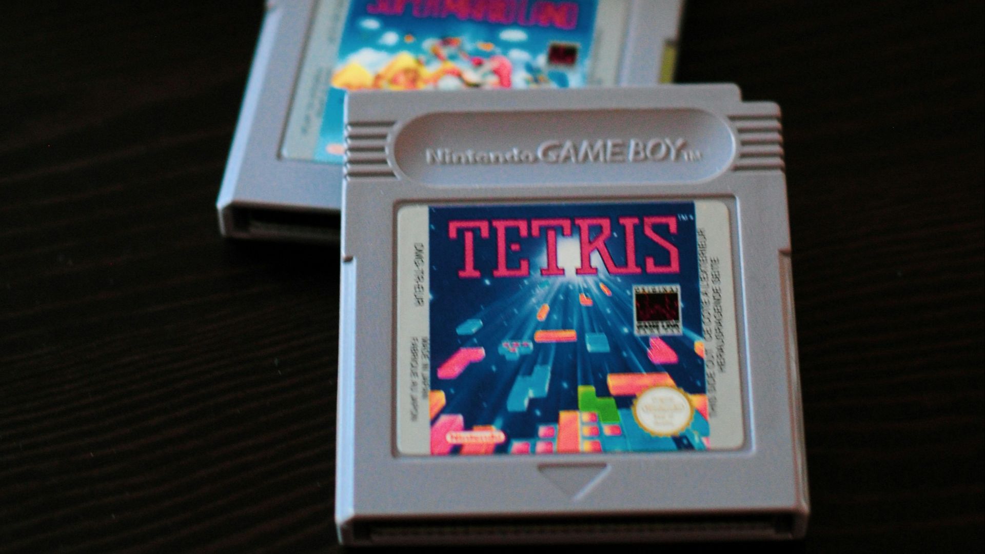 white Nintendo Game Boy controller and two cartridges