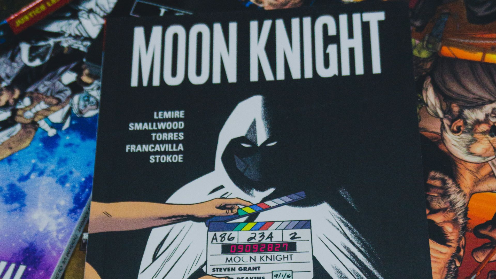 a pile of comic books sitting on top of a table