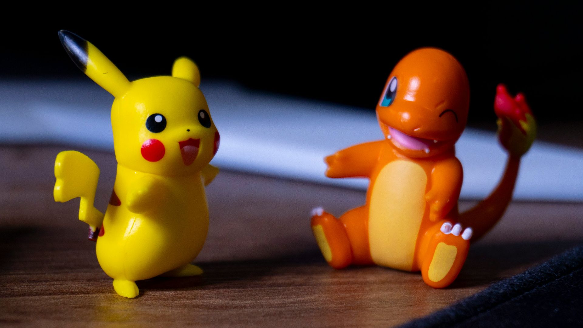 A couple of toy figurines sitting on top of a wooden table